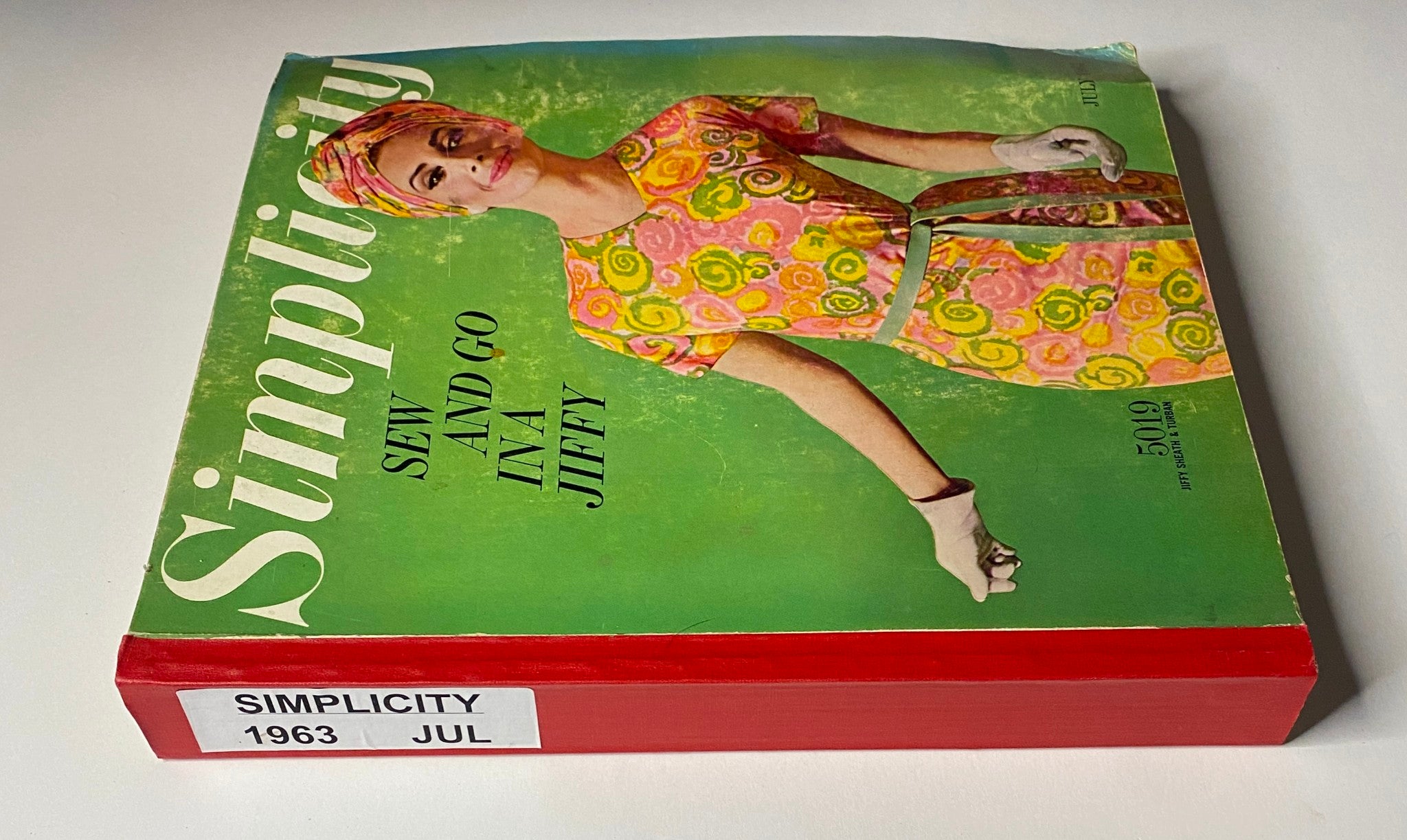 Side view of the 1963 July Simplicity Sew Catalog with the title 'Sew and Go in a Jiffy', showcasing the vibrant cover design.