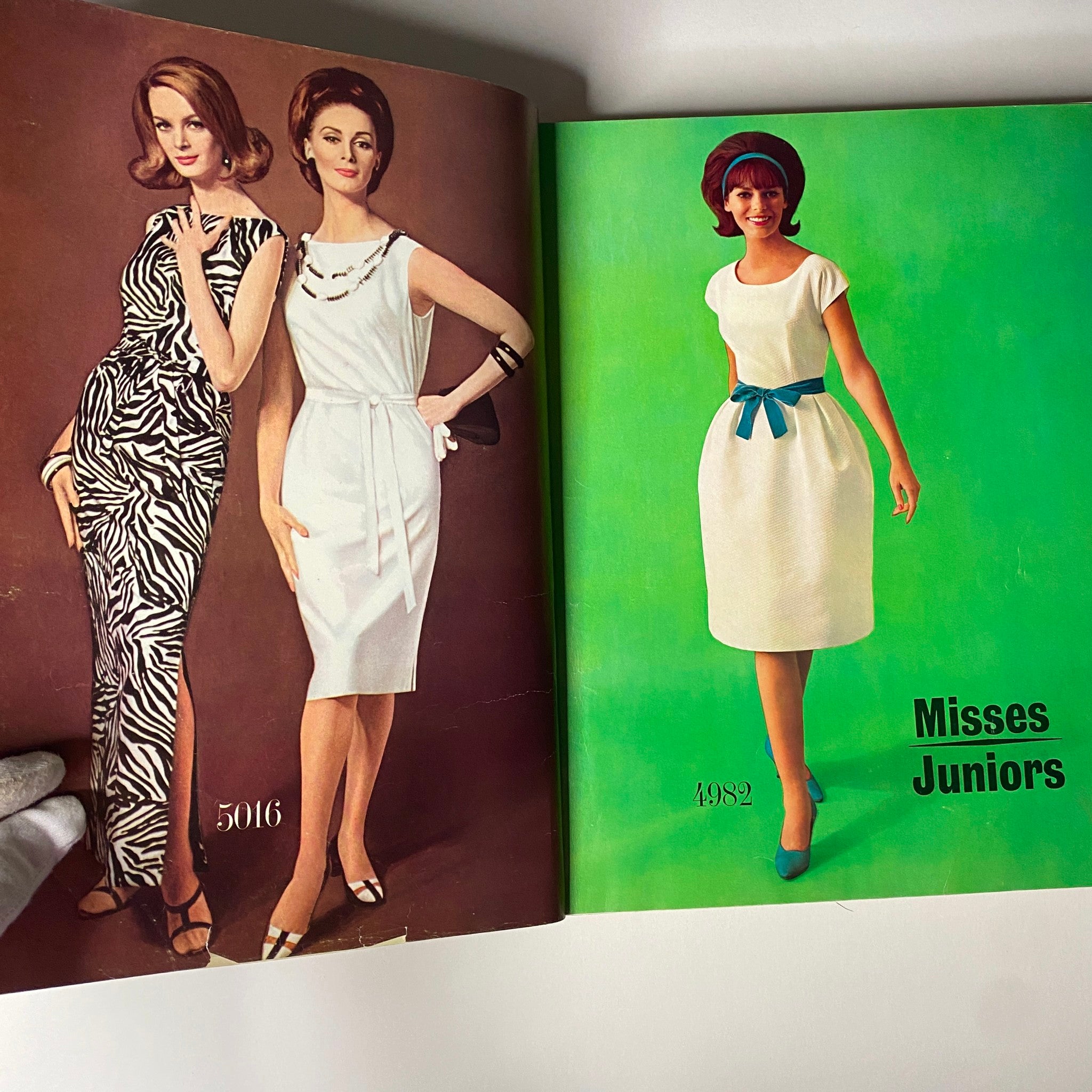 Opened pages of the 1963 July Simplicity Sew Catalog featuring fashion illustrations of dresses for Misses and Juniors.