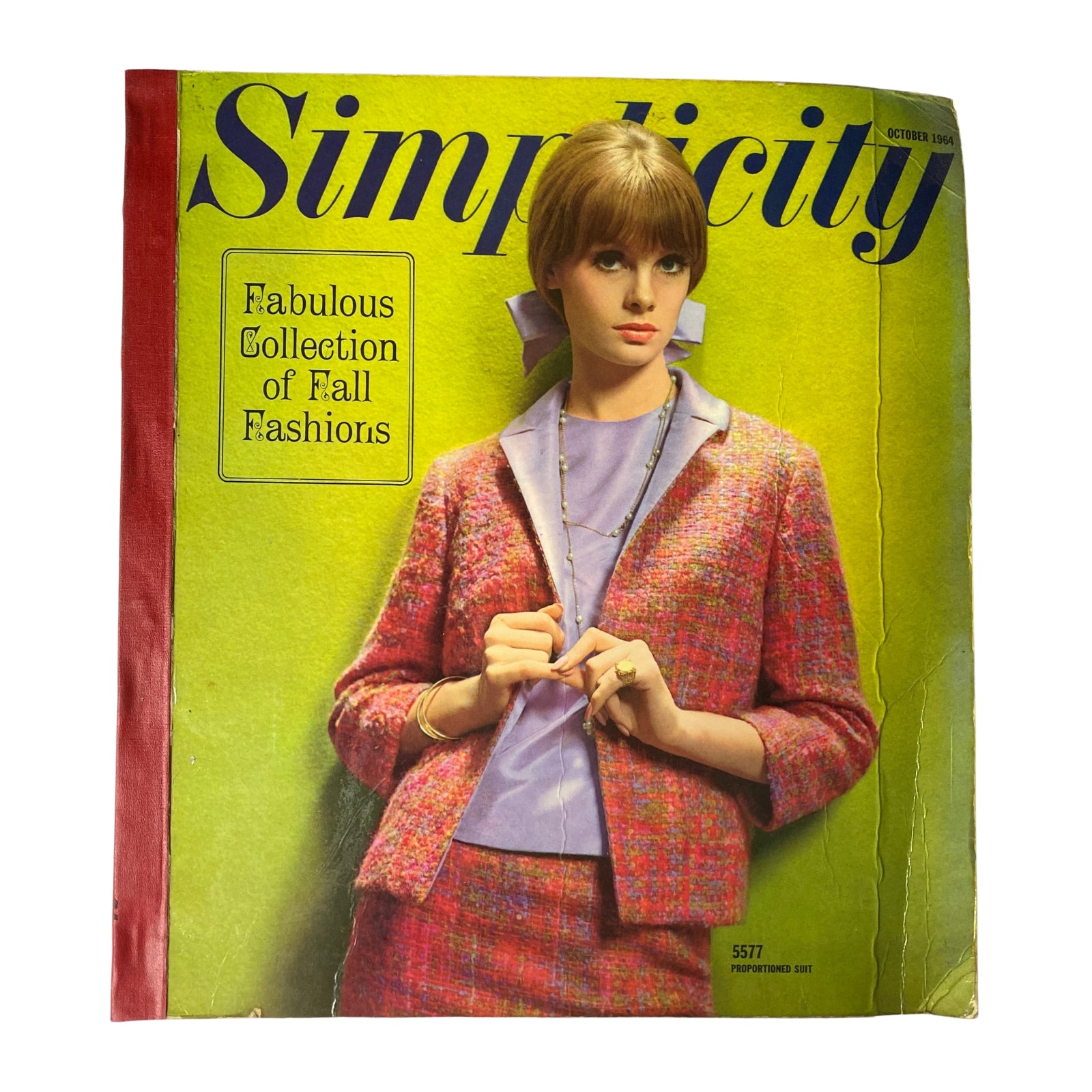 1964 October Simplicity Fall Catalog showcasing Fabulous Collection of Fall Fashions featuring a model in a stylish outfit with a colorful jacket.
