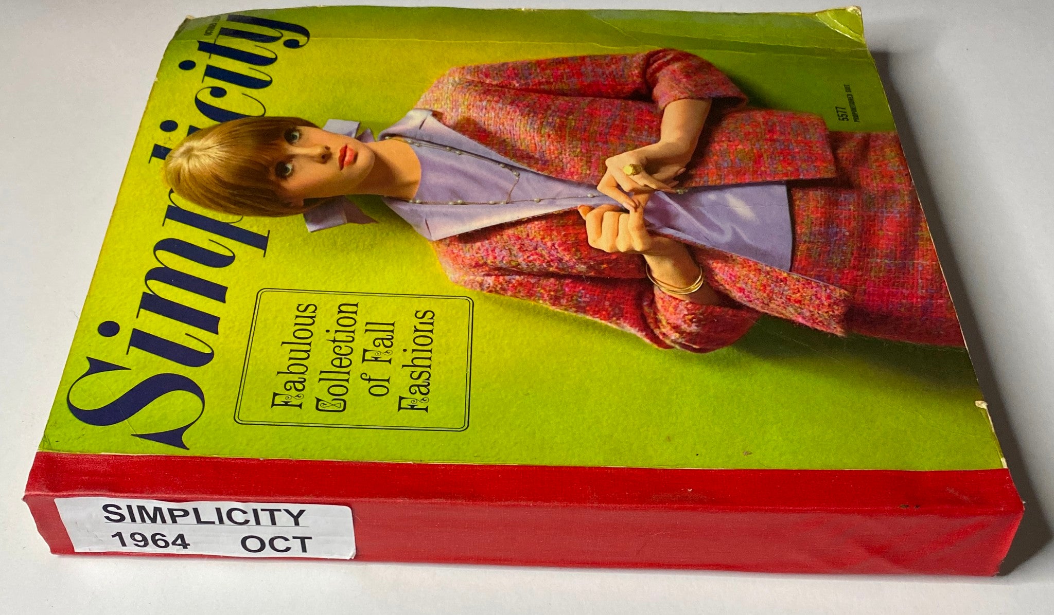 1964 October Simplicity Fall Catalog highlighting the Fabulous Collection of Fall Fashions with a side view of the model's outfit.