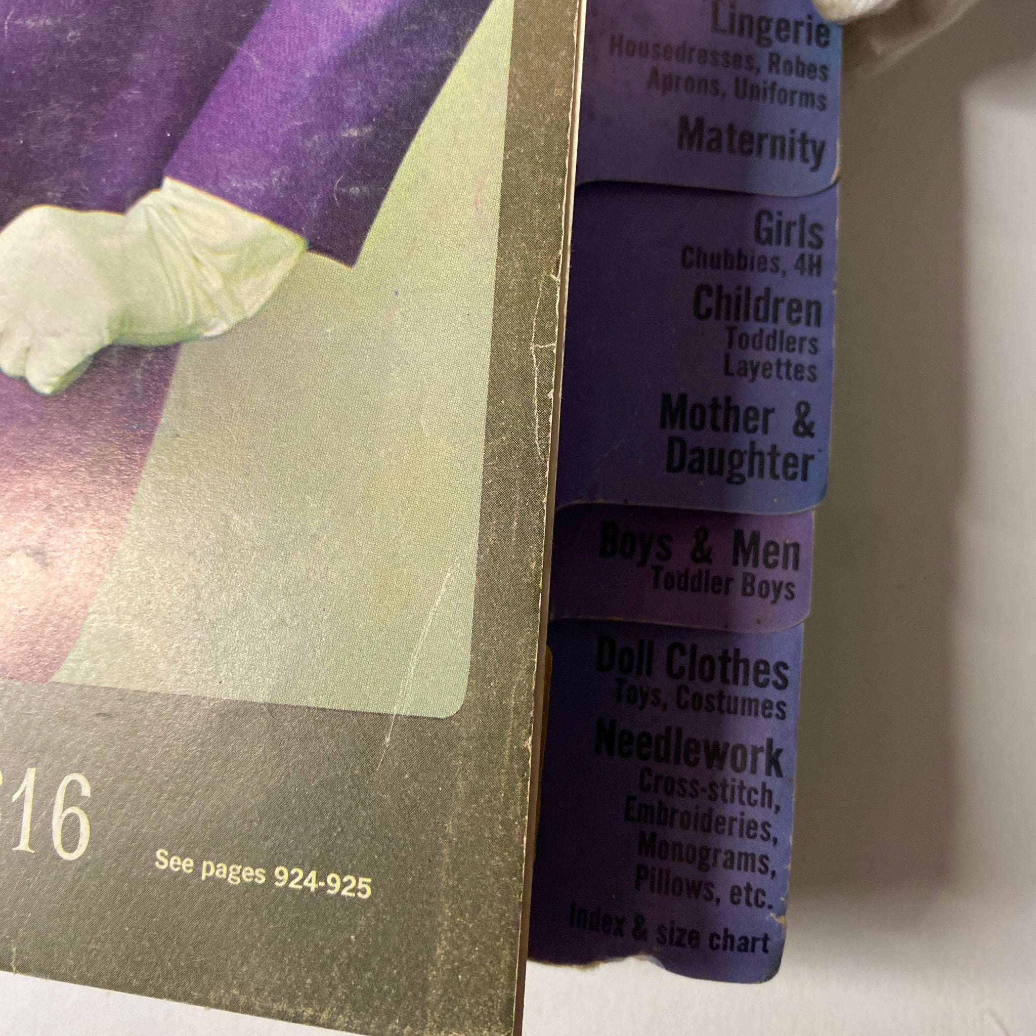 Detailed view of the 1964 October Simplicity Fall Catalog featuring fashion categories for women, children, and needlework along the edges of the catalog.