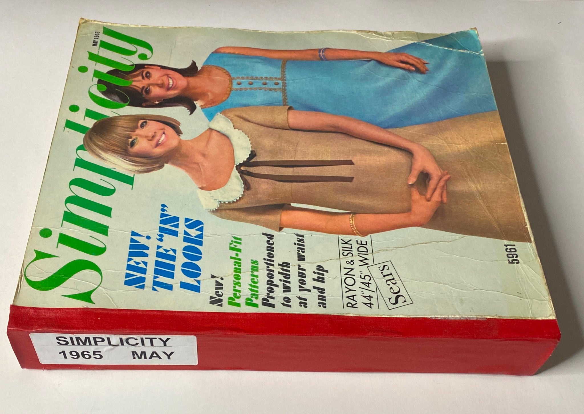 Side view of the 1965 May Simplicity Catalog Sewing Pattern, highlighting the title and vintage design details.