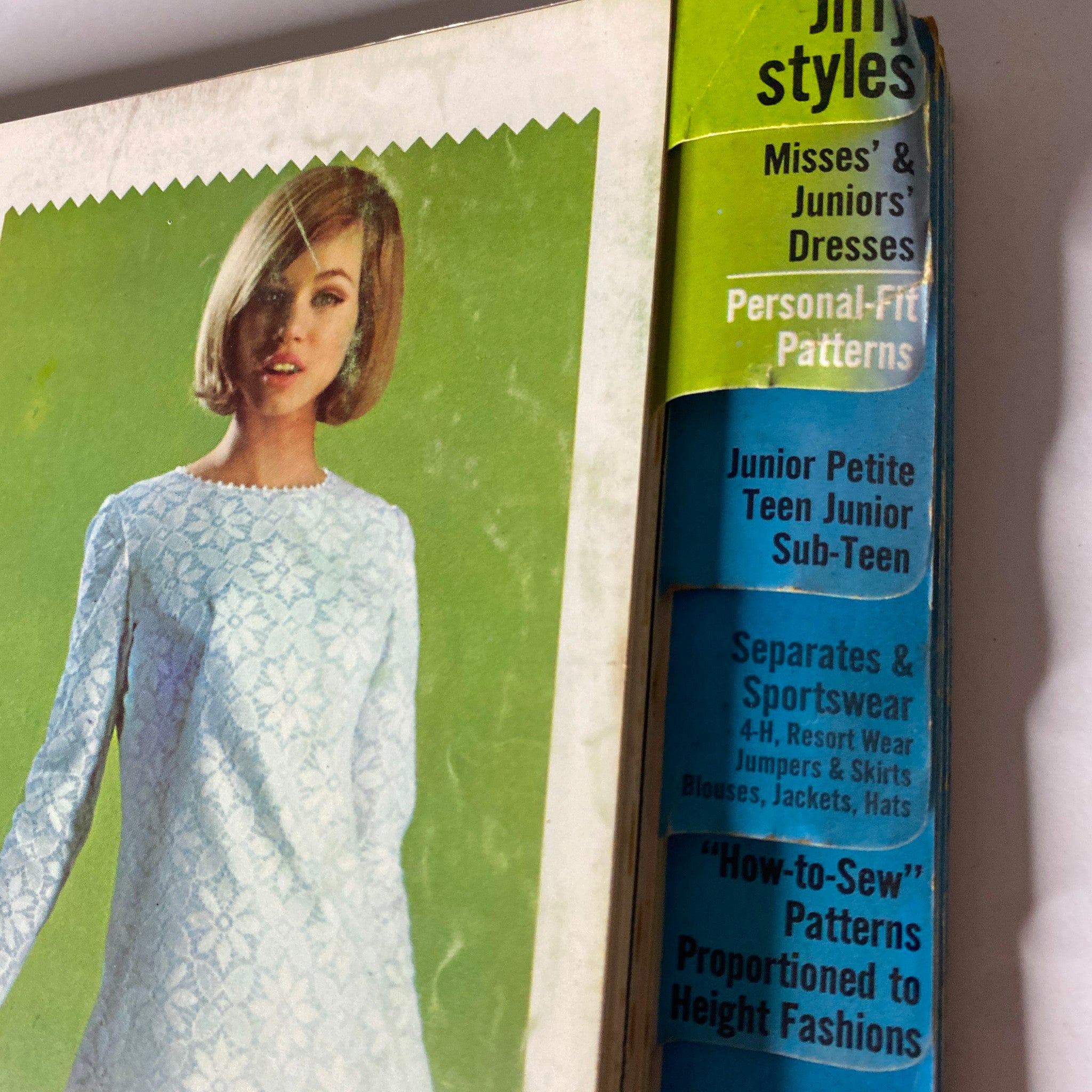 Cover of the 1965 May Simplicity Catalog featuring a model in a blue lace dress, highlighting Jiffy Styles, Misses', and Juniors' Dresses.