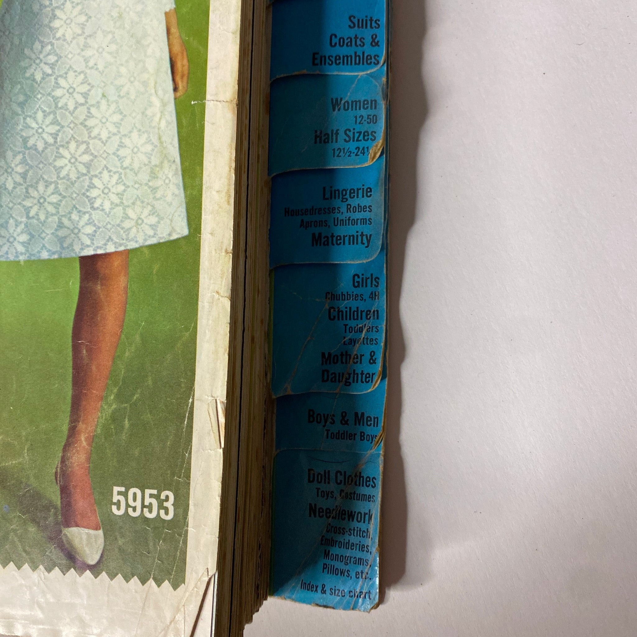Side view of the 1965 May Simplicity Catalog displaying dress options for women, including Lingerie, Girls, and Maternity wear.