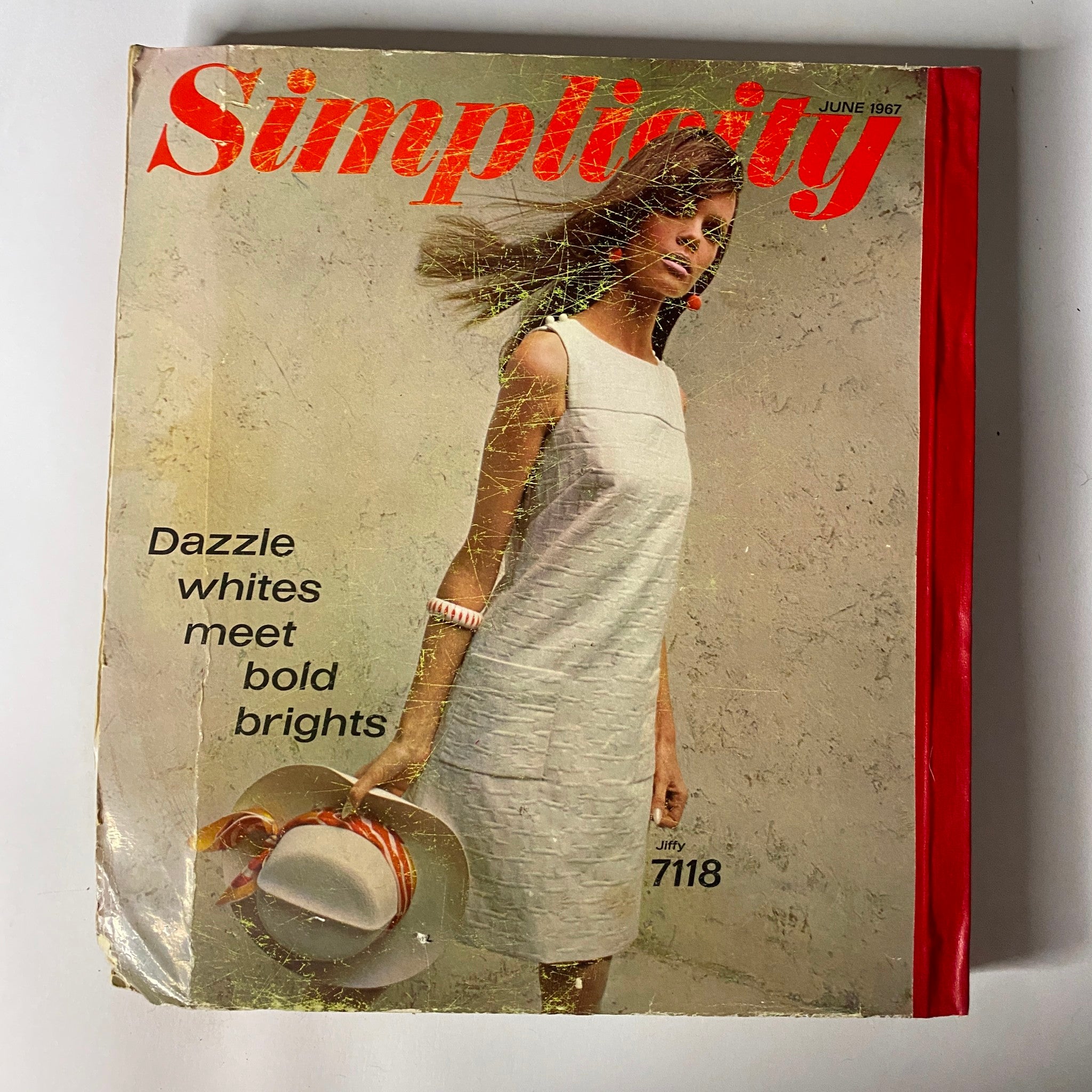 1967 June Simplicity Sewing Pattern Catalog cover featuring a stylish model in a white dress, emphasizing bold fashion from the 1960s.