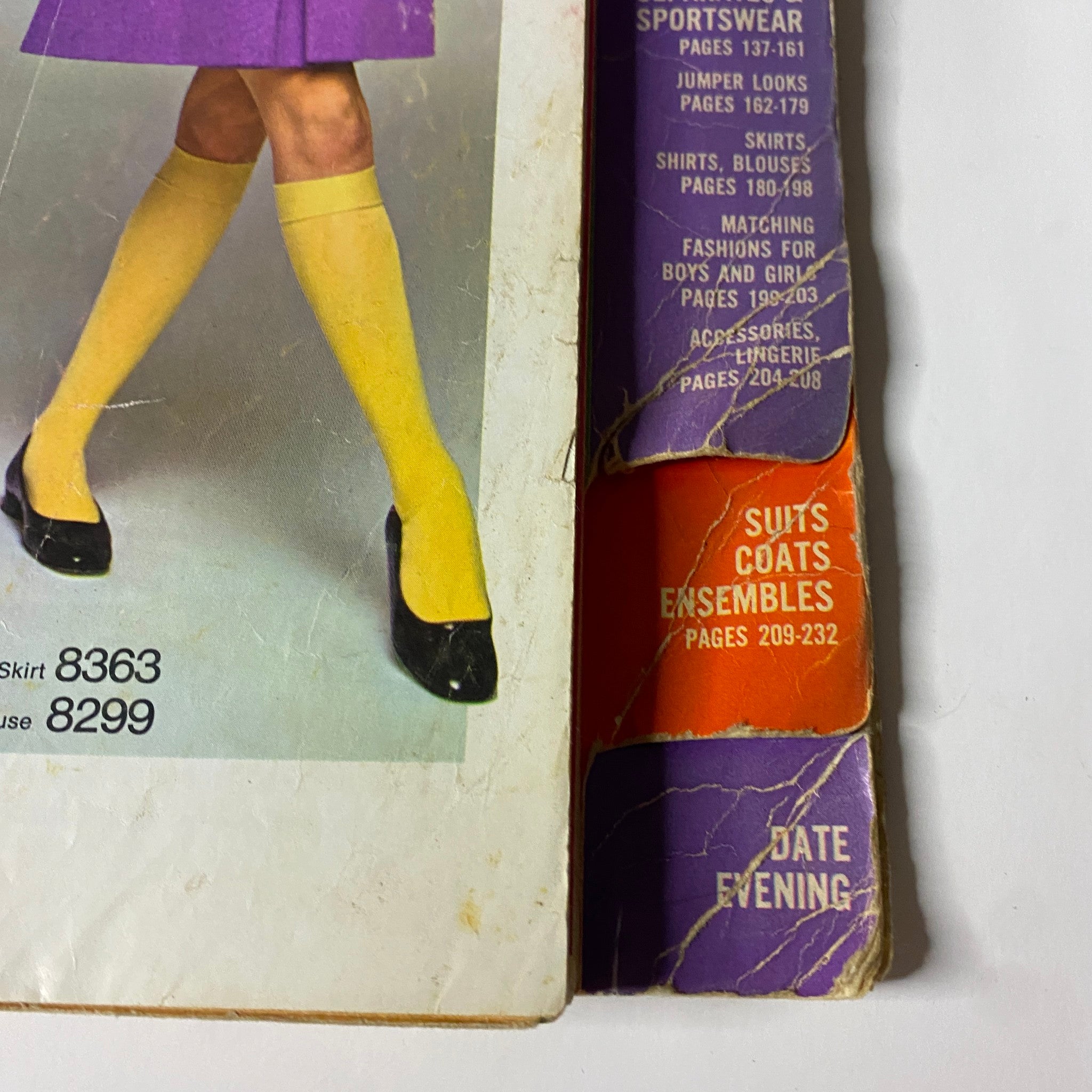 Fashion illustration from the 1969 Simplicity Fall and Winter School Catalog showcasing a model wearing a purple skirt and yellow tights, with sections for Separates & Sportswear and Suits & Coats.