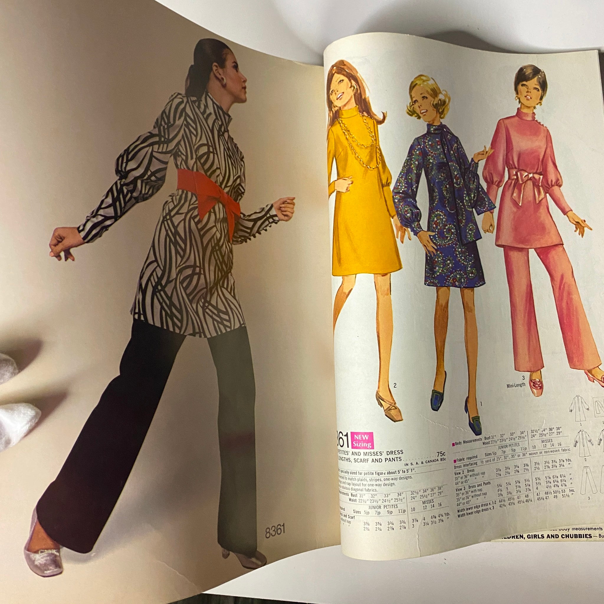 1969 Simplicity Fall and Winter School Catalog featuring sewing patterns, showcasing a model in a striking patterned dress paired with wide-leg trousers, along with other fashion illustrations.