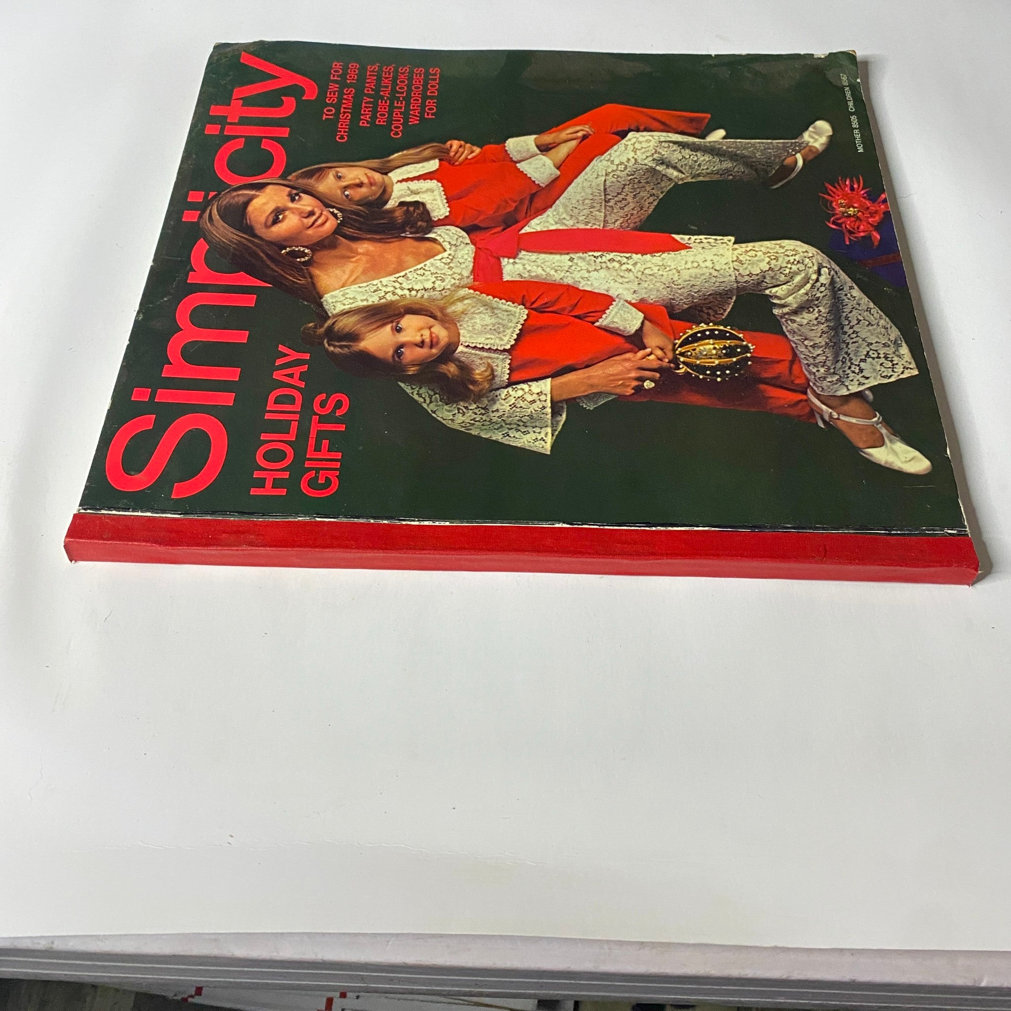 1969 Simplicity Holiday Catalog Sewing Pattern featuring models in festive holiday outfits, showcasing stylish sewing projects and winter fashion.