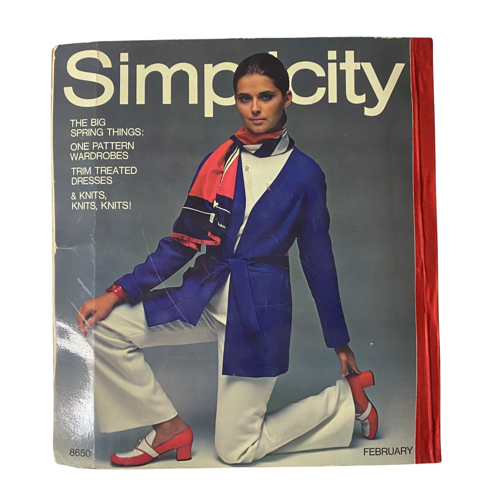 1969 February Simplicity Spring Catalog featuring a stylish young woman in a blue jacket and white pants, promoting spring fashion trends and designs from Simplicity patterns.