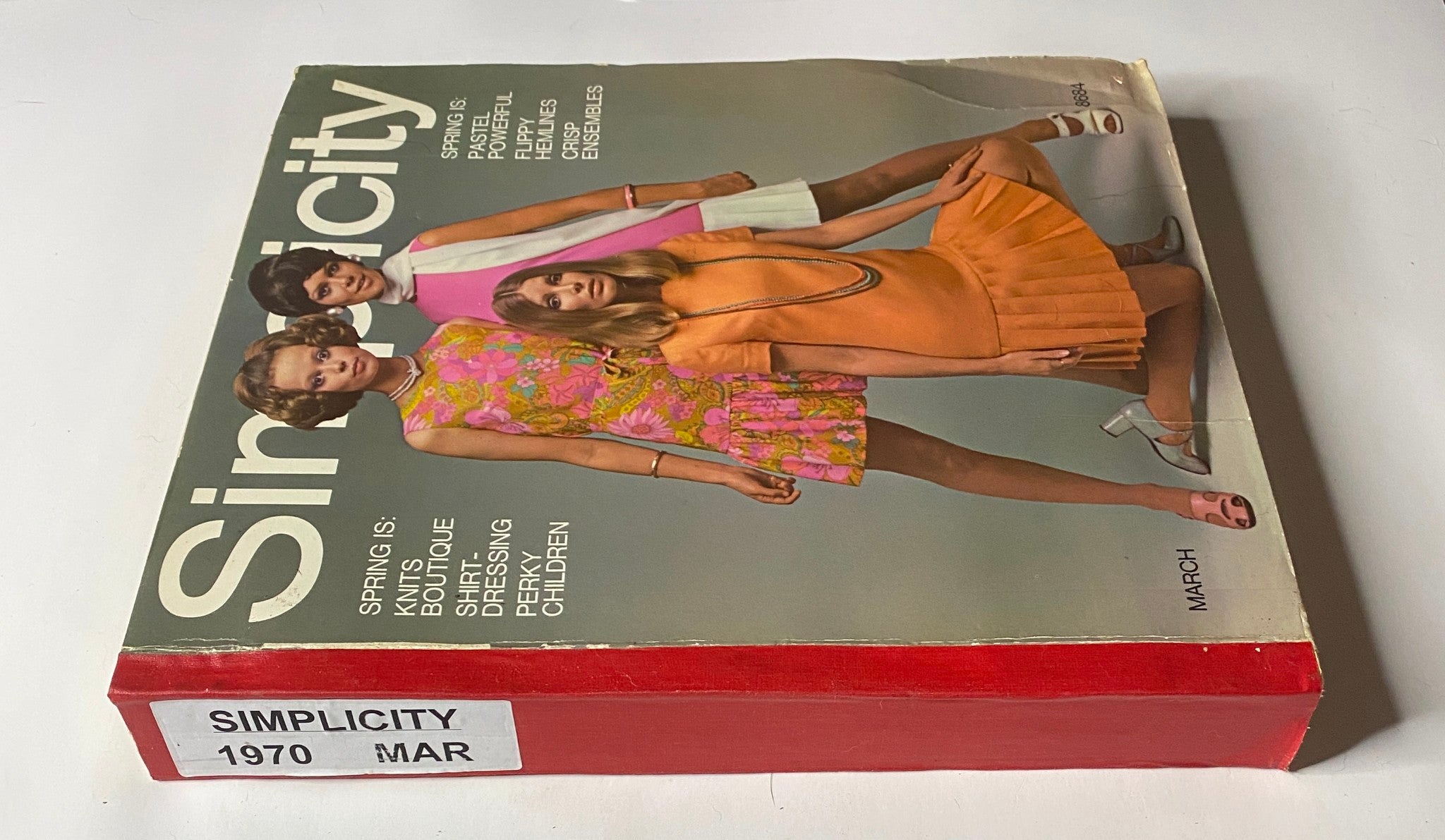 Side view of the 1970 March Simplicity Spring Catalog revealing the title and colorful sections, a valuable resource for sewing patterns reflecting early 1970s style.