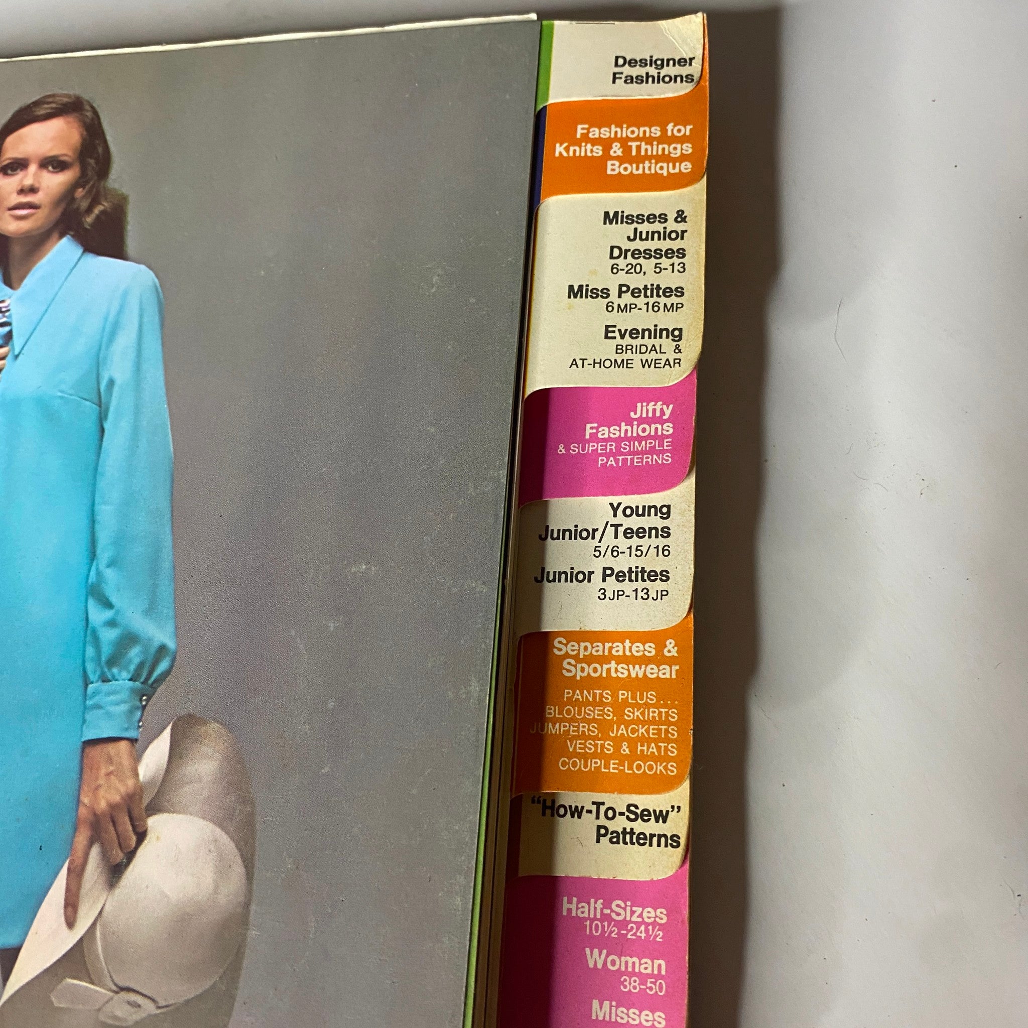 Close-up of the side spine of the 1970 March Simplicity Spring Catalog highlighting various pattern categories like Designer Fashions and Jiffy Patterns, ideal for sewing hobbyists.