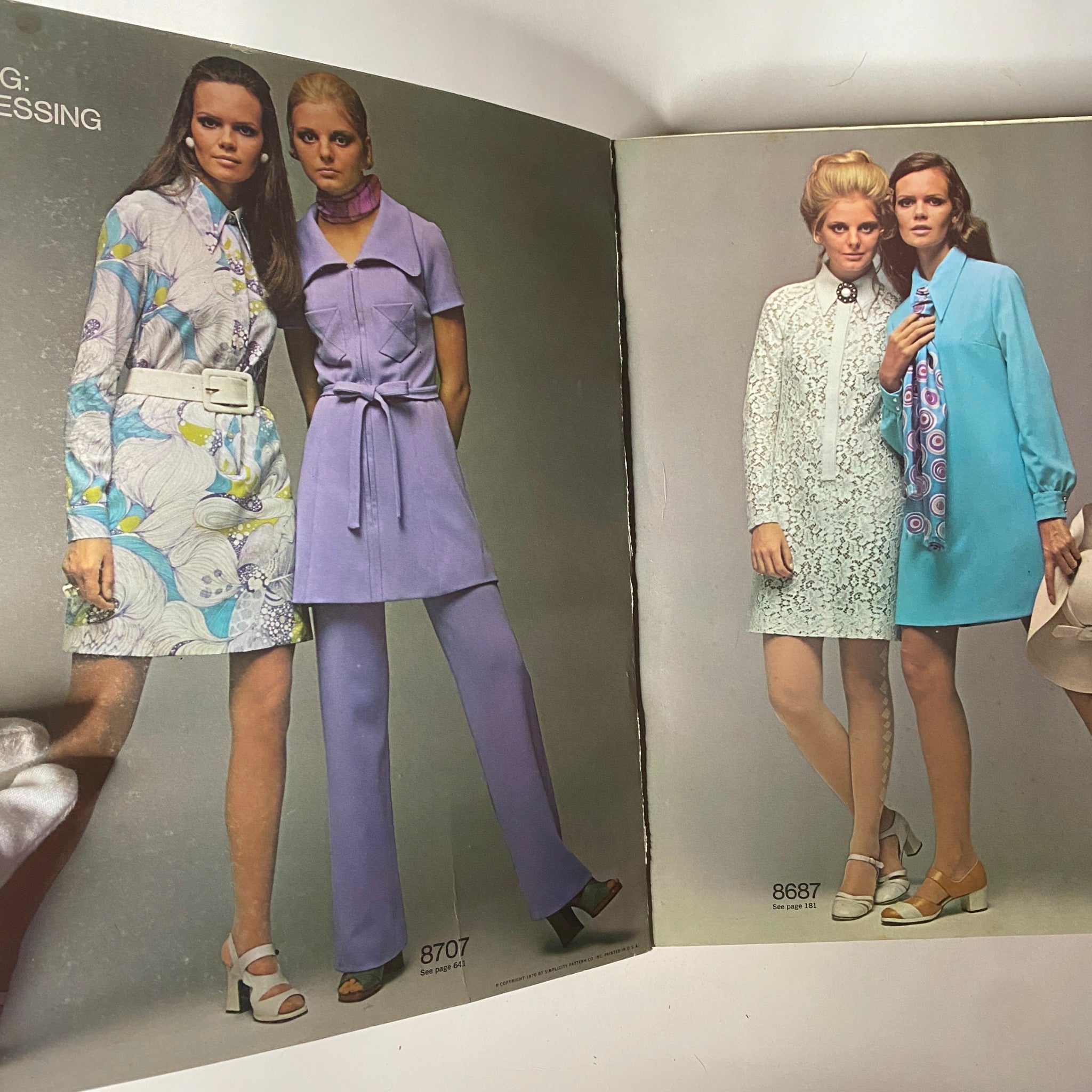 Vintage 1970 March Simplicity Spring Catalog featuring two models showcasing stylish outfits, one in a colorful dress and the other in a chic purple ensemble, reflecting 70s fashion trends.