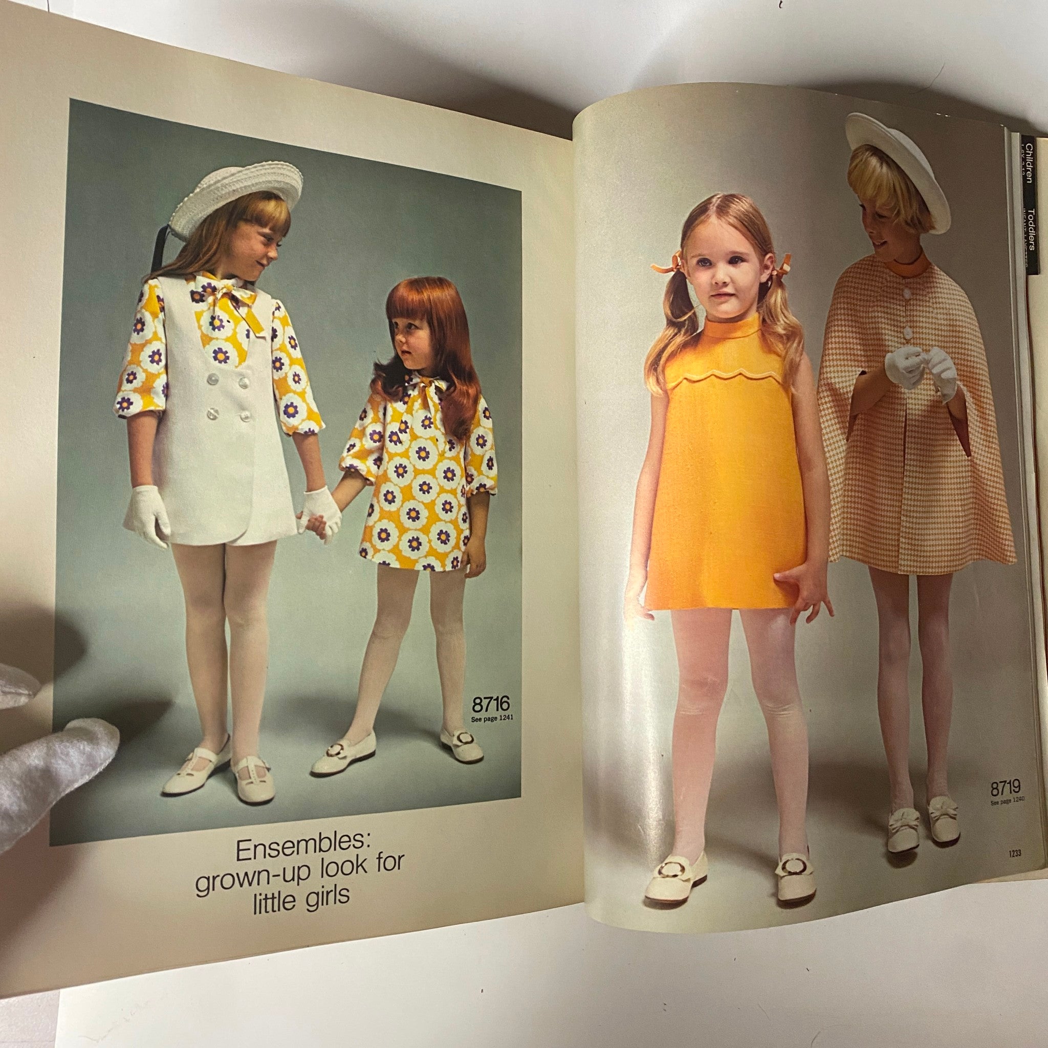 Illustration from the 1970 March Simplicity Spring Catalog displaying ensemble ideas for young girls, featuring stylish dresses and accessories, capturing the essence of 1970s children's fashion.