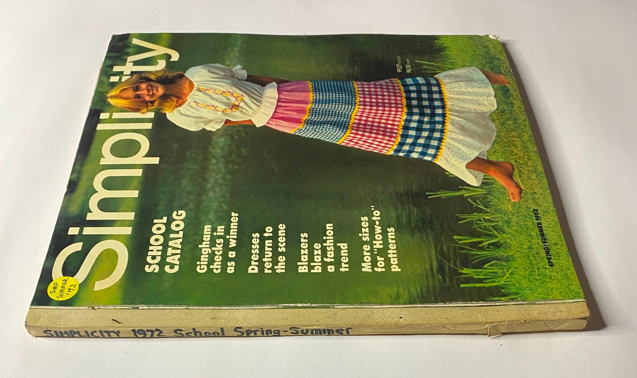 Cover of the 1972 Simplicity Spring and Summer Catalog featuring a girl in a colorful skirt and a casual top, promoting cheerful 1970s fashion.