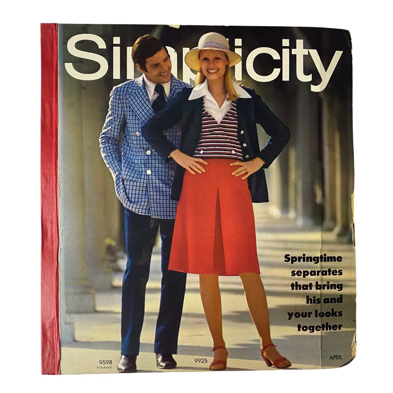 1972 April Simplicity Spring Catalog sewing pattern store counter book showcasing vibrant early '70s fashion featuring a man in a plaid blazer and a woman in a striped and red outfit. Ideal for vintage sewing enthusiasts.