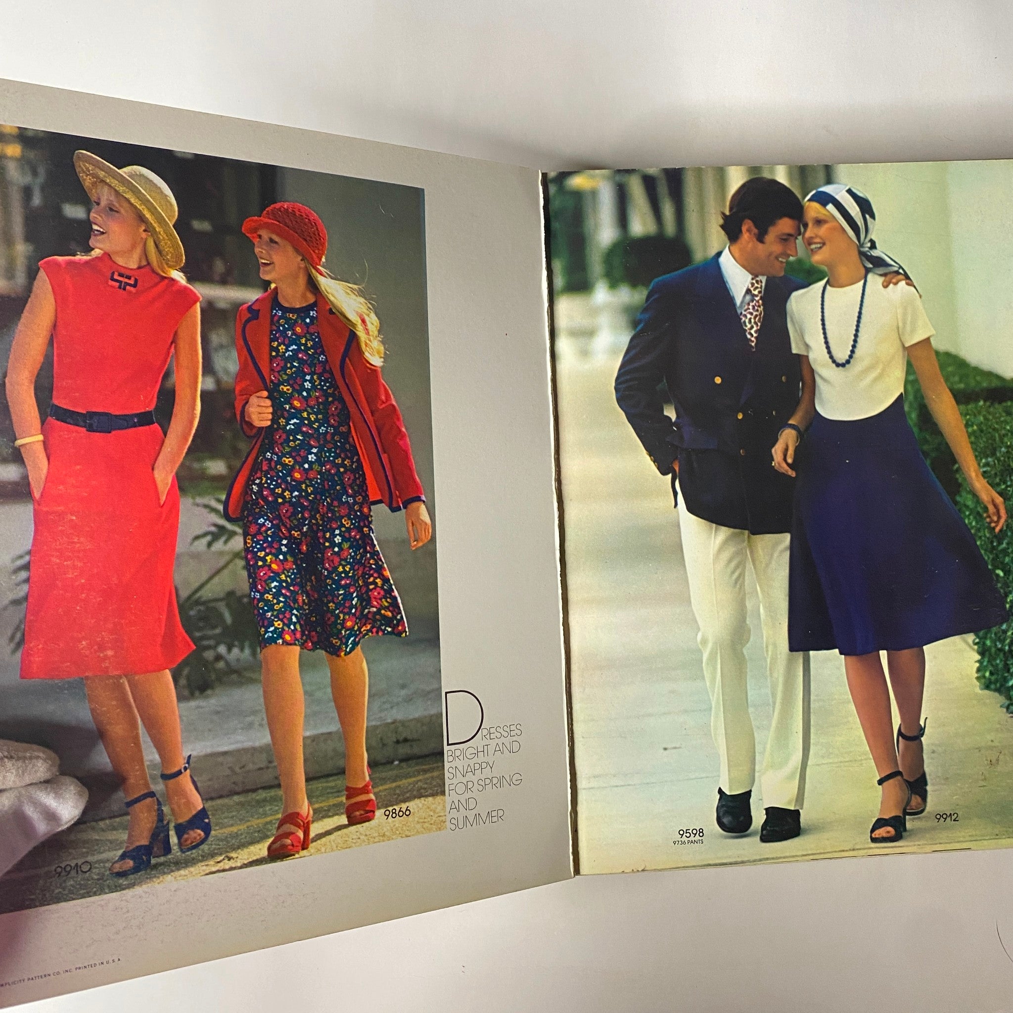 1972 April Simplicity Spring Catalog sewing pattern showcasing vibrant spring fashion, featuring two women in colorful dresses and a man in a suit, represents early '70s style.