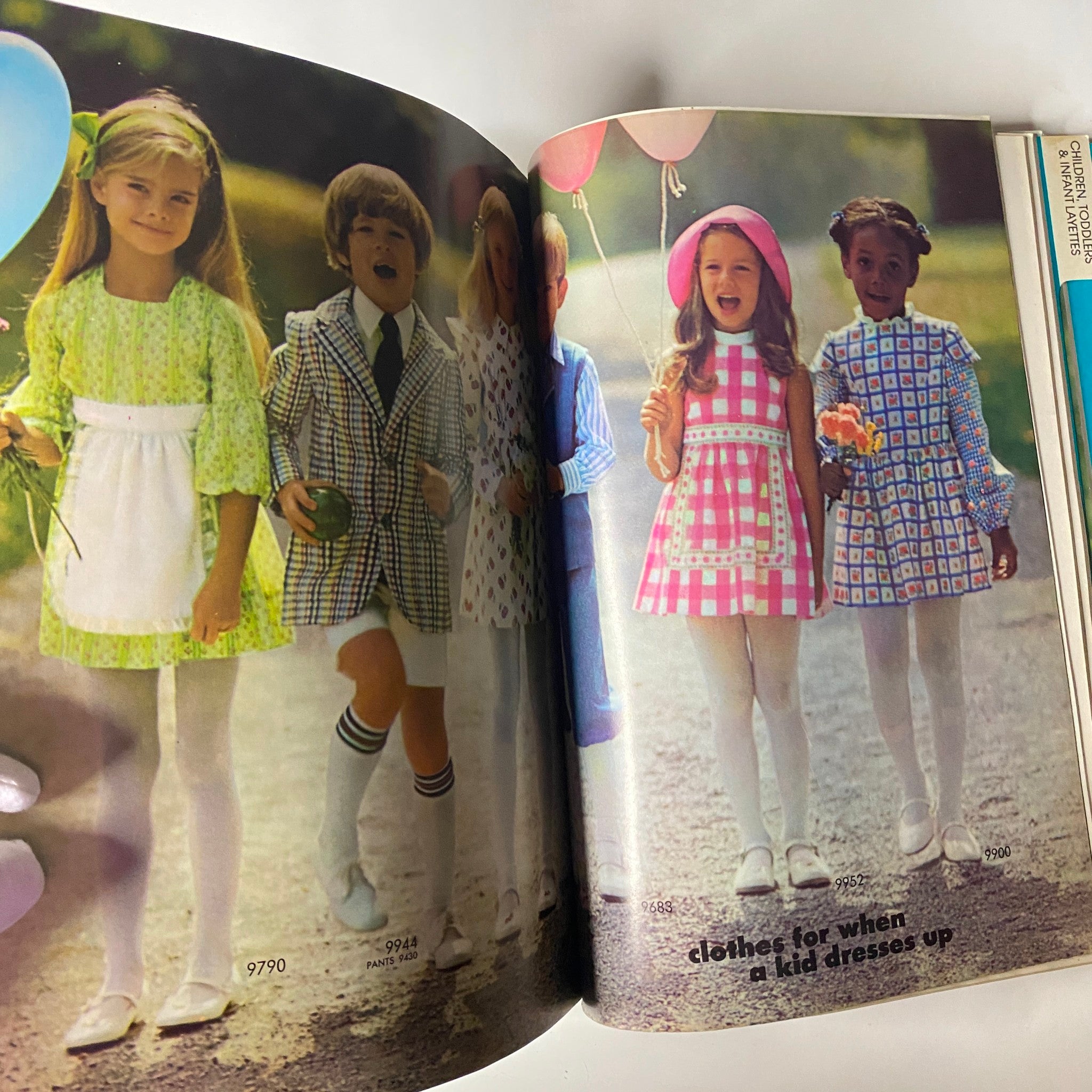 1972 April Simplicity Spring Catalog showcasing children's fashion with colorful outfits for girls and boys, including dresses and playful suits.