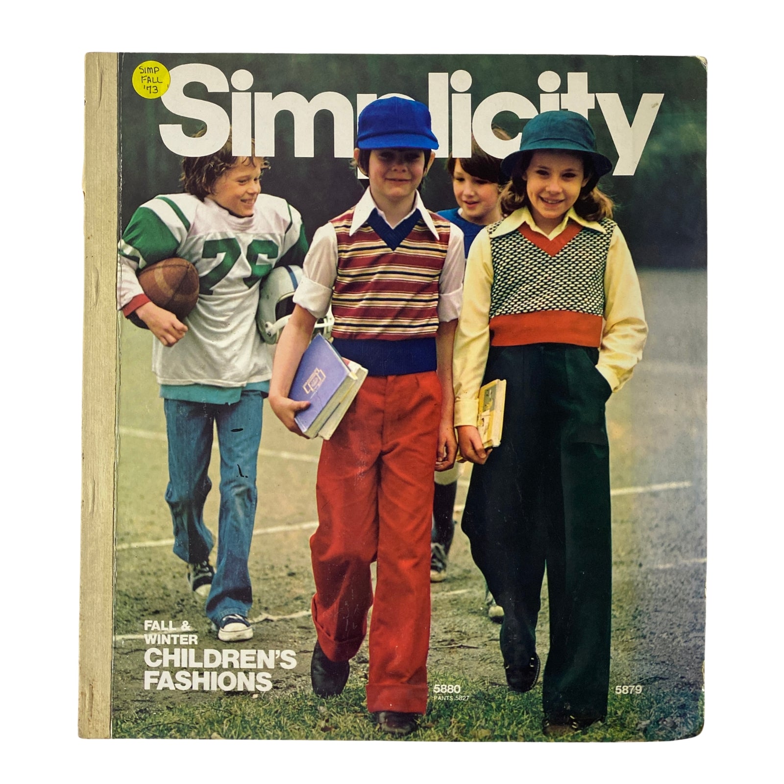 Cover of the 1973 Simplicity Fall and Winter Catalog showcasing children's fashion, featuring kids in stylish clothing on a playground.