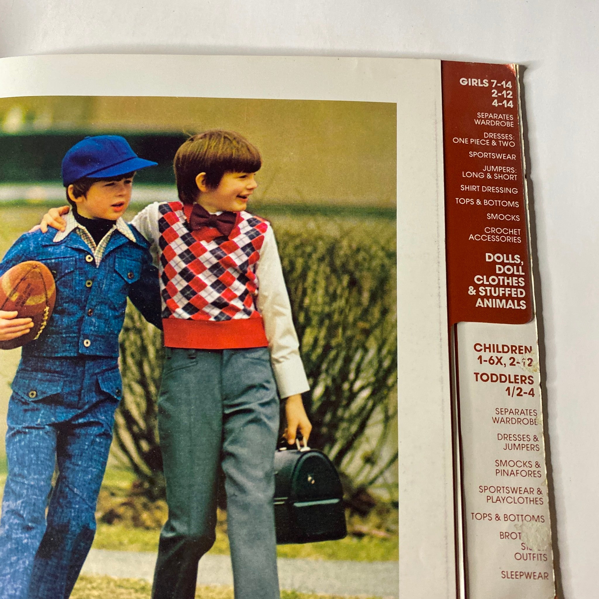 Interior page of the 1973 Simplicity Fall and Winter Catalog highlighting styles for girls and boys, featuring various children's outfits and a football.