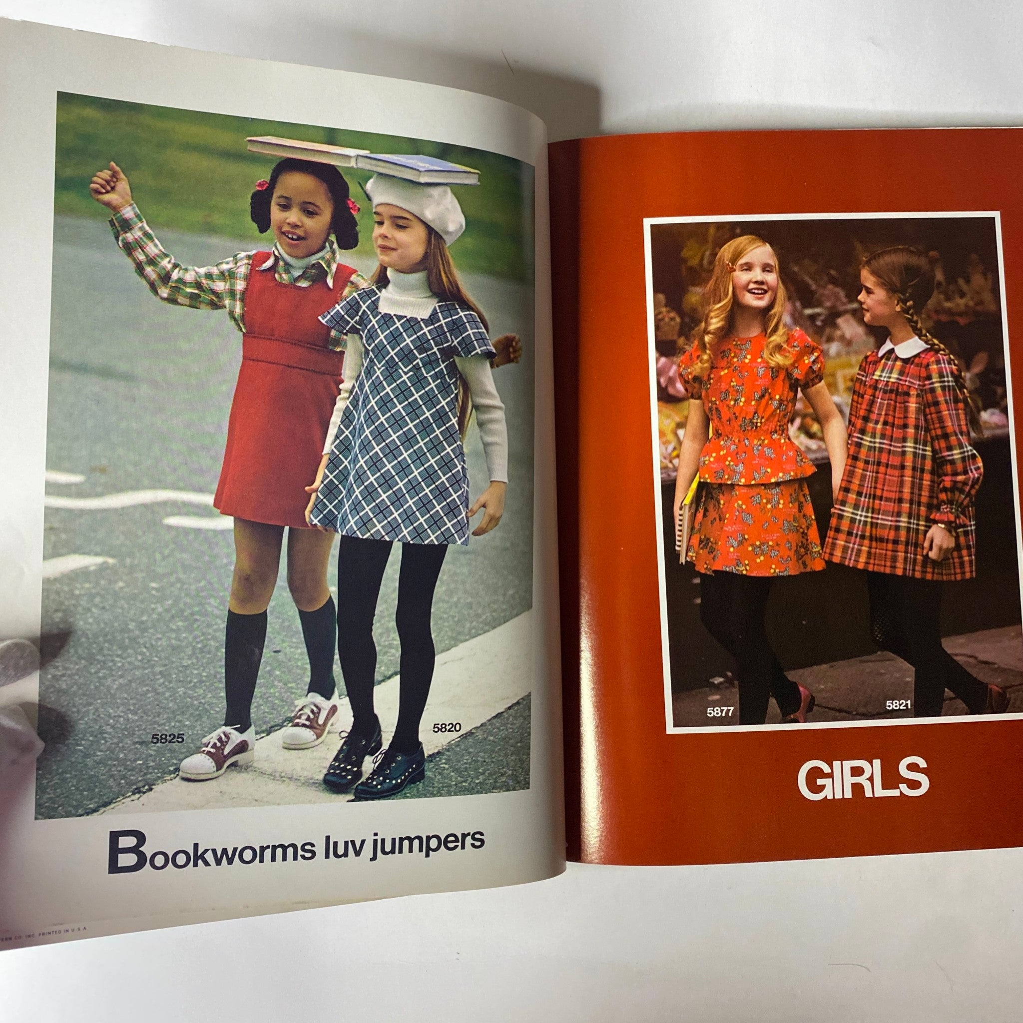 1973 Simplicity Fall and Winter Catalog showcasing children in playful jumpers, featuring colorful styles suitable for girls' fashion during the 1970s.