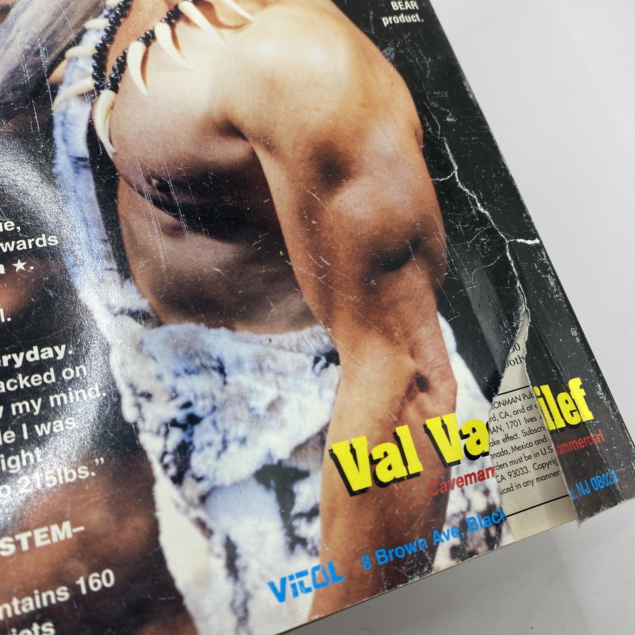 Detail of Iron Man Magazine December 2000 showing a close-up of the back cover with visible wear, including a rip, emphasizing the magazine's vintage character.
