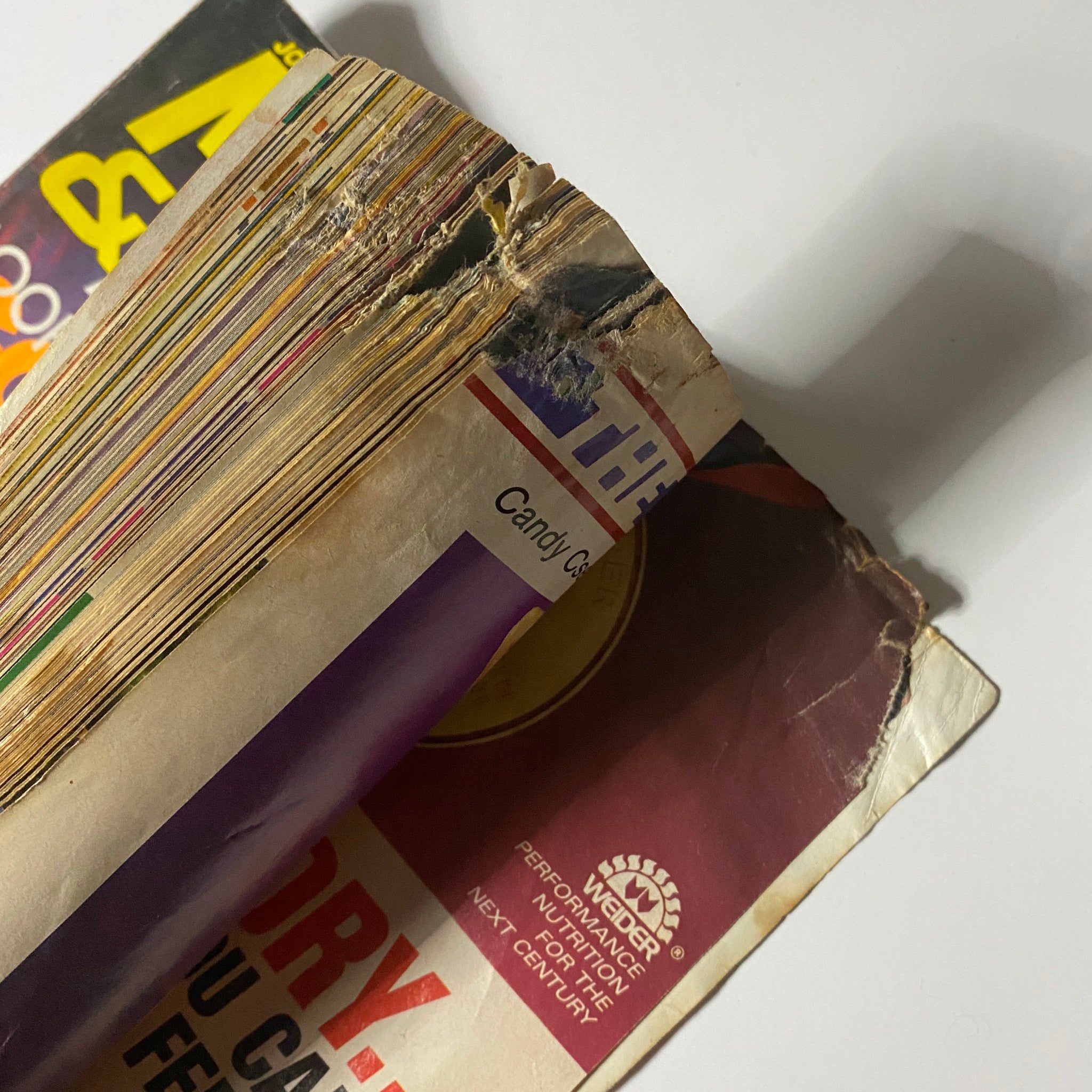 Spine view of Muscle & Fitness Magazine September 1989, highlighting wear and age, indicative of its collectible nature.