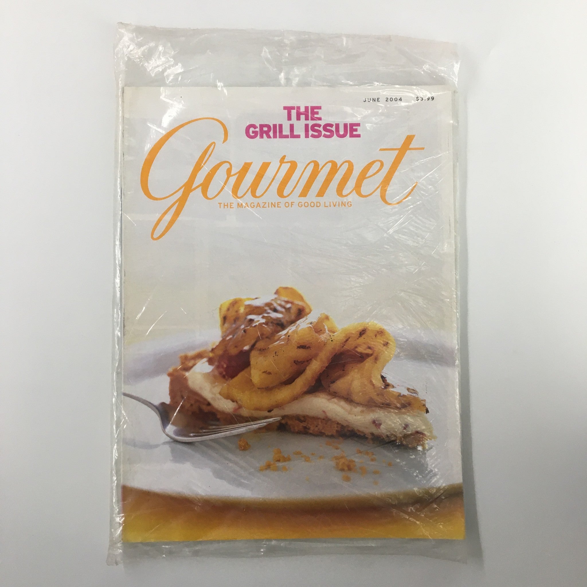 Gourmet Magazine June 2004 cover featuring Grilled Pineapple Tart with Raspberries Cream, sealed in plastic for collectors.