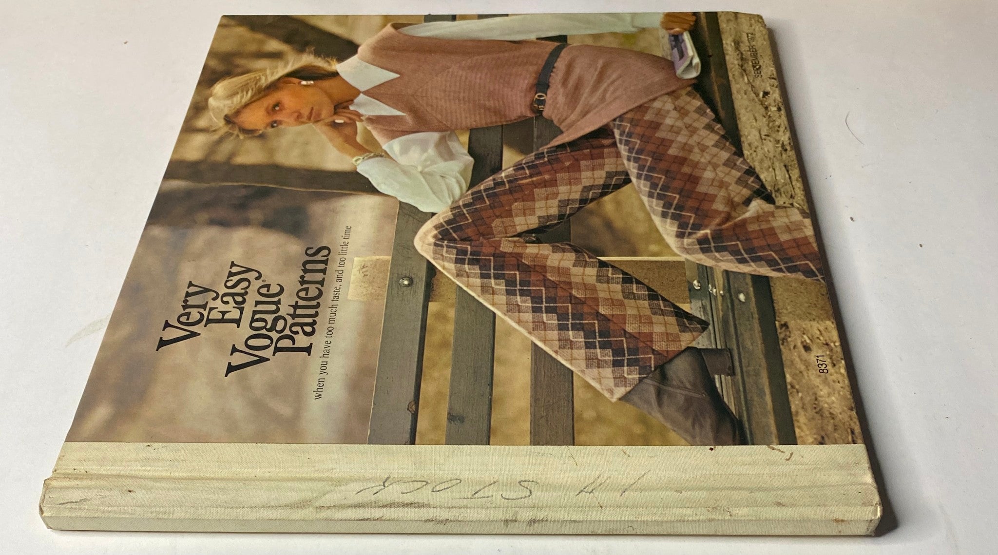 Close-up view of the 1972 Vogue Patterns September Catalog highlighting a model's fashion, wearing a stylish vest and patterned pants, reflecting the vintage design aesthetic.