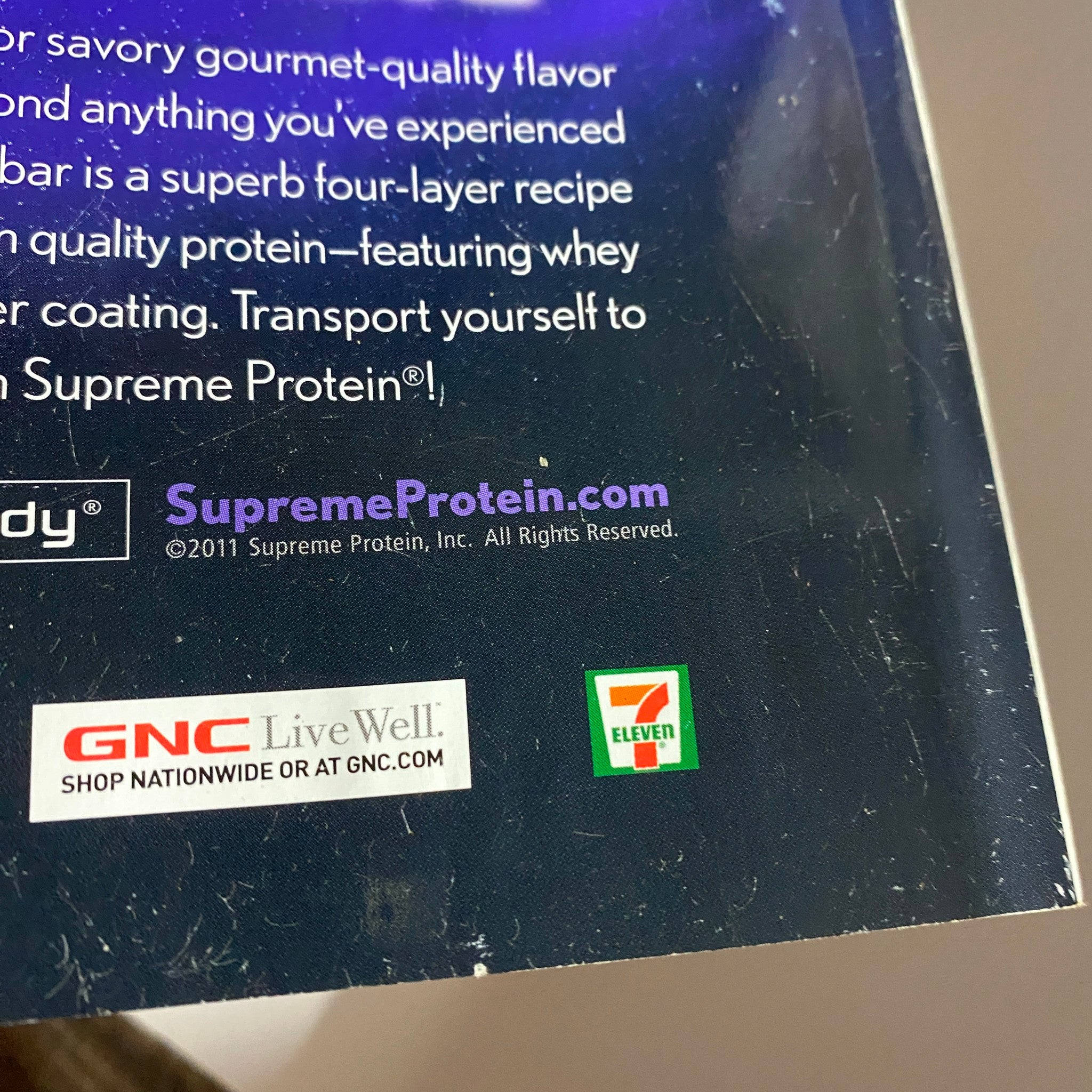 Iron Man Magazine July 2011 Vol 70 No. 7 page showcasing promotional details for Supreme Protein with branding logos from GNC and 7-Eleven.