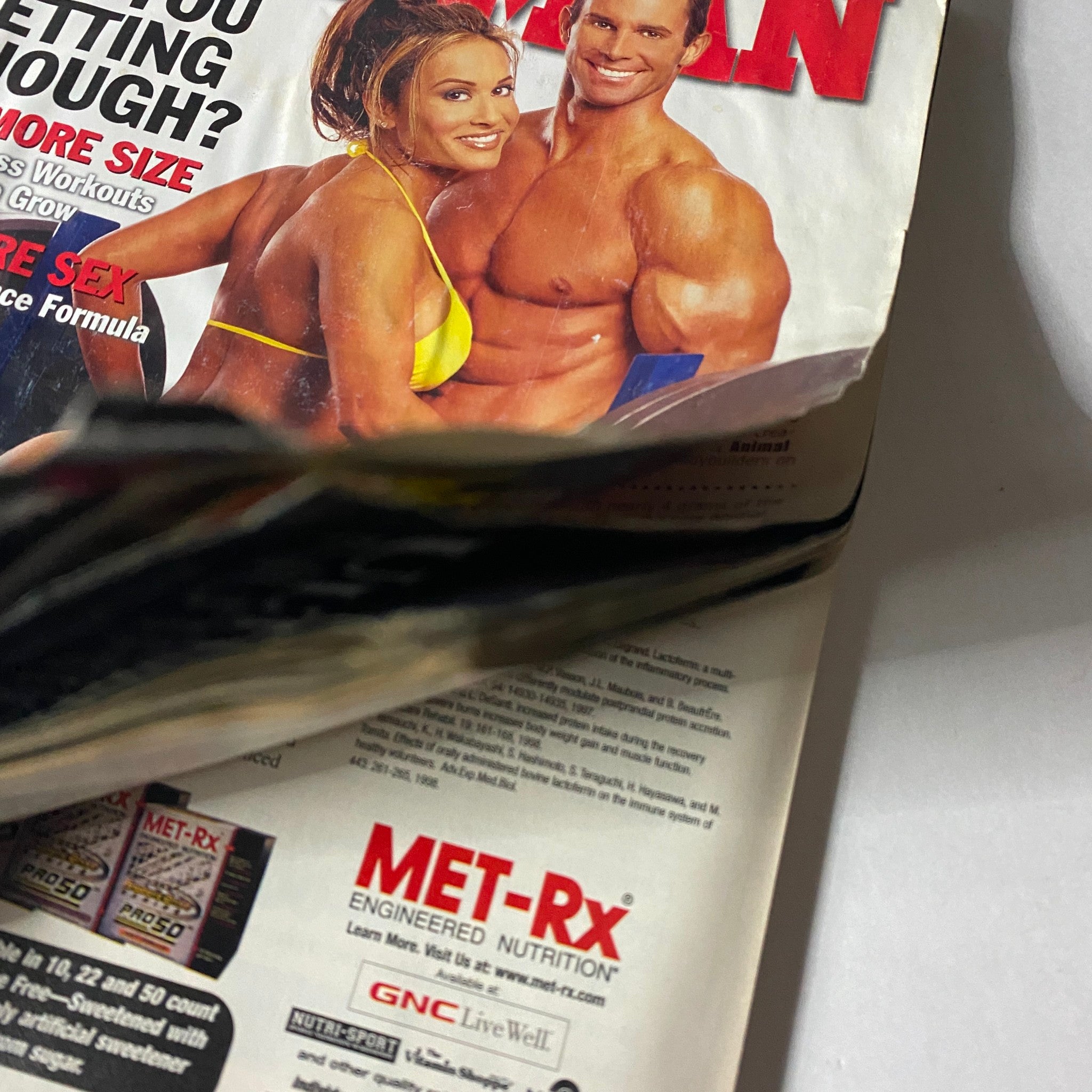 Cover image of Iron Man Magazine January 2001 Vol 60 No. 1 featuring a fitness model in a yellow bikini alongside a fitness enthusiast showcasing muscular physique, highlighting themes of health and wellness.