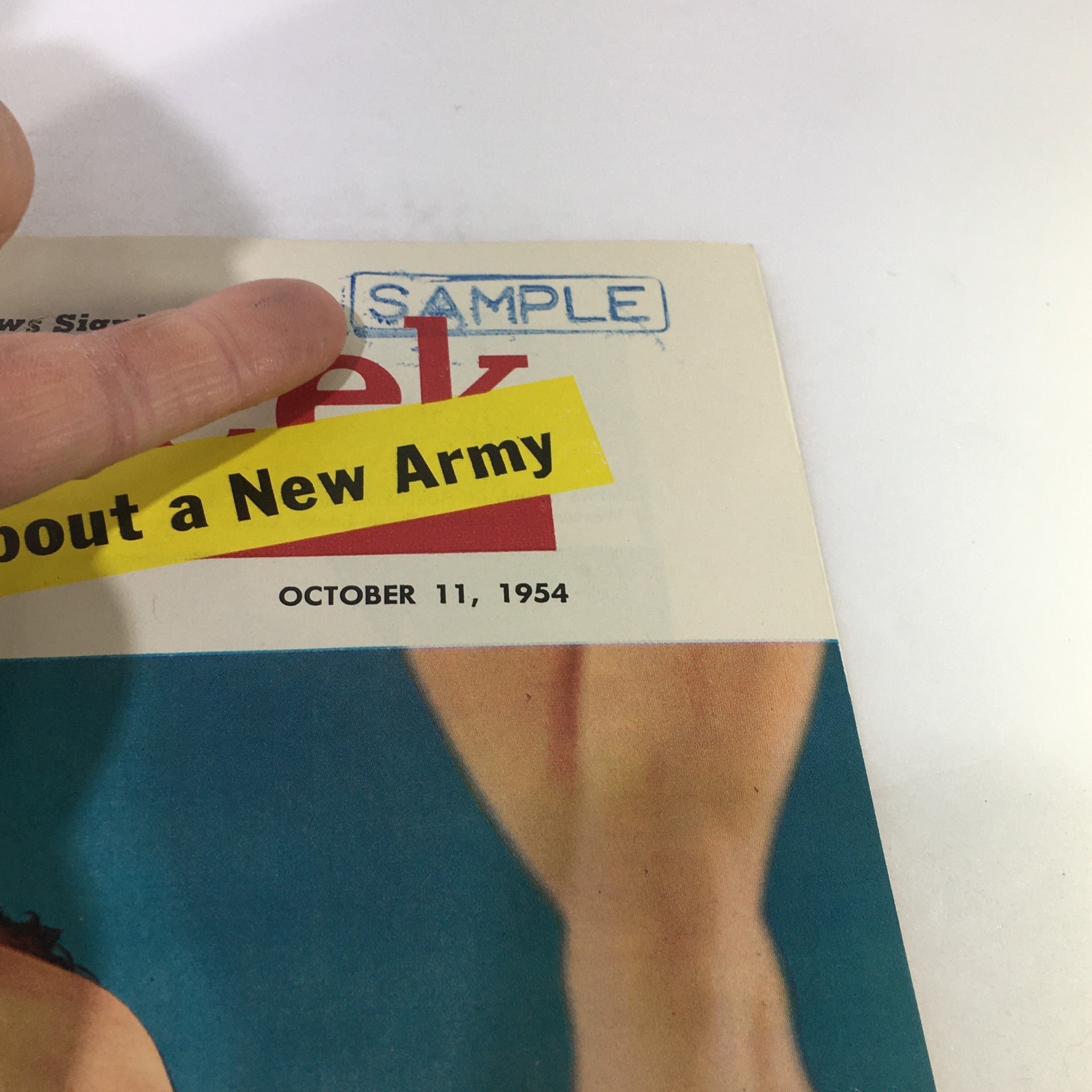 Close-up of the VTG Newsweek Magazine from October 11, 1954, featuring a bold yellow sample label, the publication date, and a glimpse of artwork related to ballet.