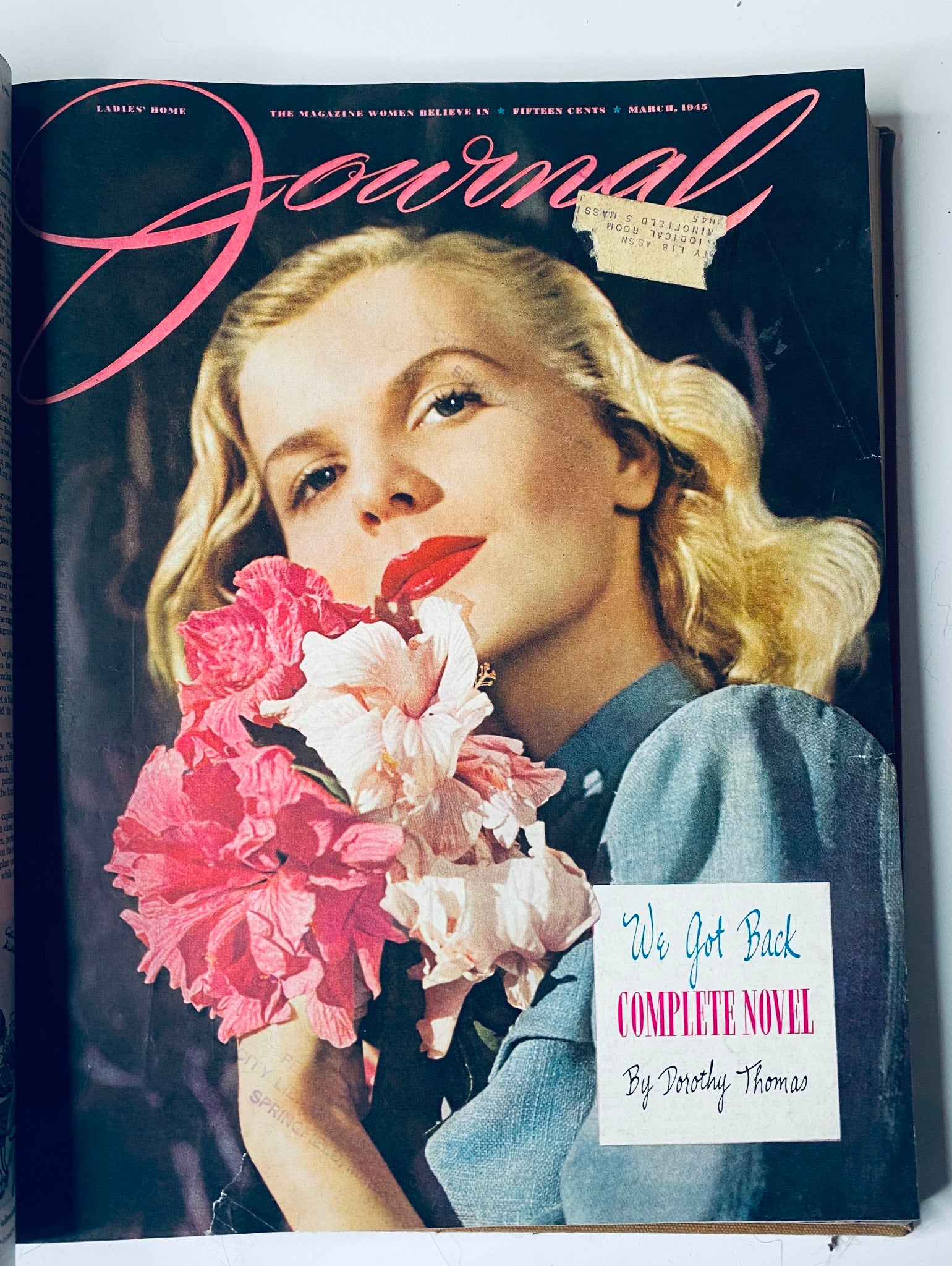 Cover of Ladies' Home Journal March 1945 featuring a woman holding colorful flowers with the title 'We Got Back' - part of the complete library bound magazine collection for 1945.