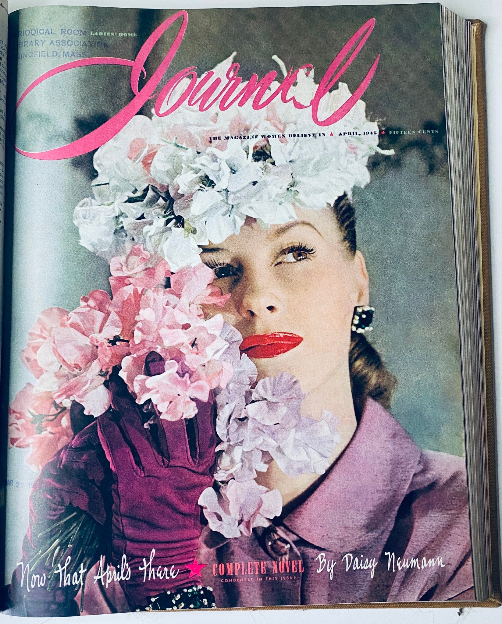 Cover of Ladies' Home Journal April 1945 displaying a woman adorned with flowers, holding a glove, with the title 'Now That April's There' - included in the 1945 library bound magazine collection.