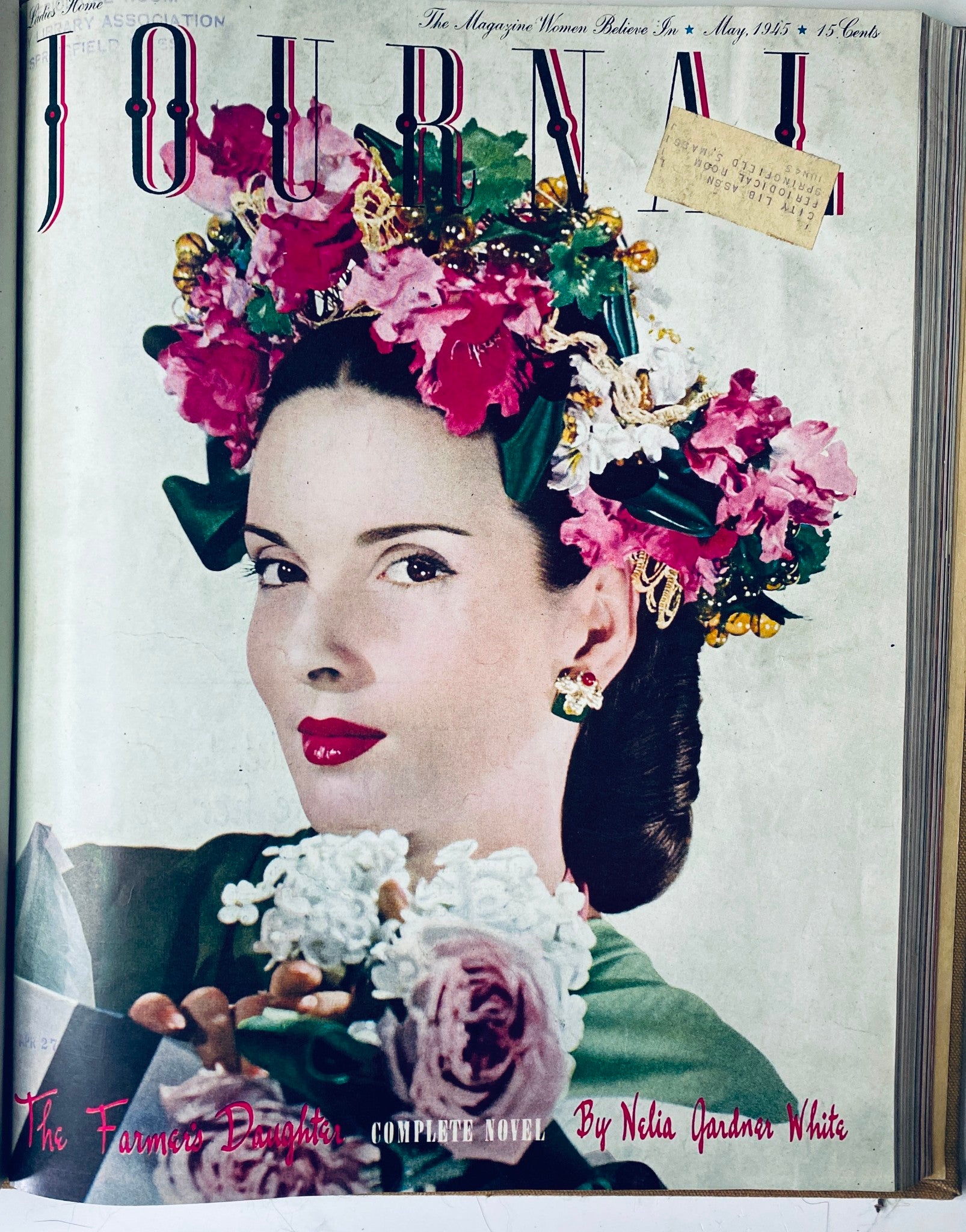 Cover page of Ladies' Home Journal, May 1945 edition, featuring a woman adorned with flowers, emphasizing vintage fashion and lifestyle.