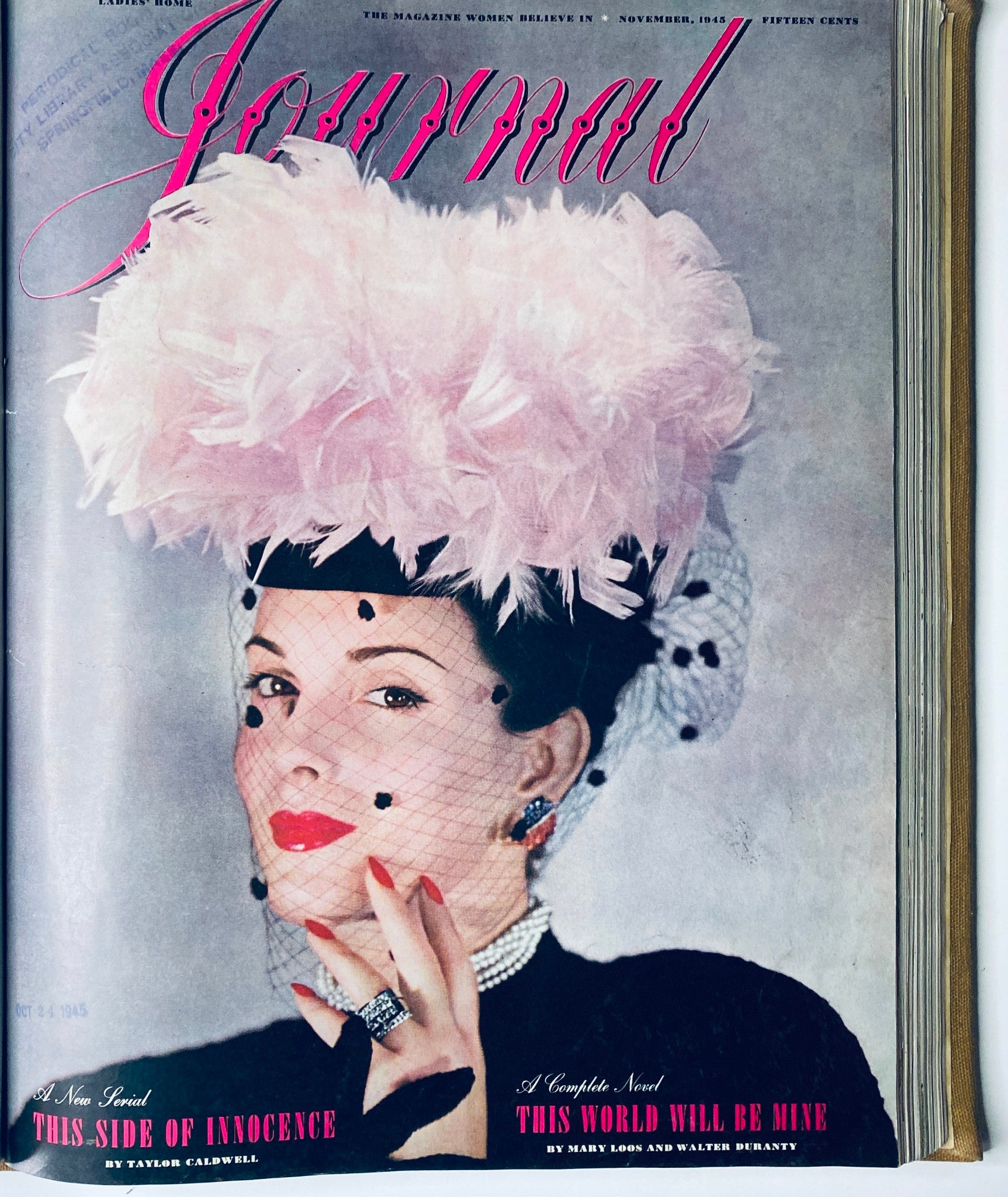 Cover of Ladies' Home Journal Bound Magazine for November 1945, showcasing a glamorous woman with a feathered hat, emphasizing elegance in post-war fashion.