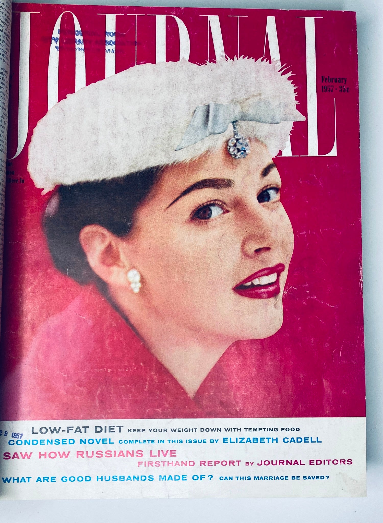 Ladies' Home Journal: February 1957. Cover features a woman wearing a stylish white hat and red lipstick, with attractive headlines on health and relationships.