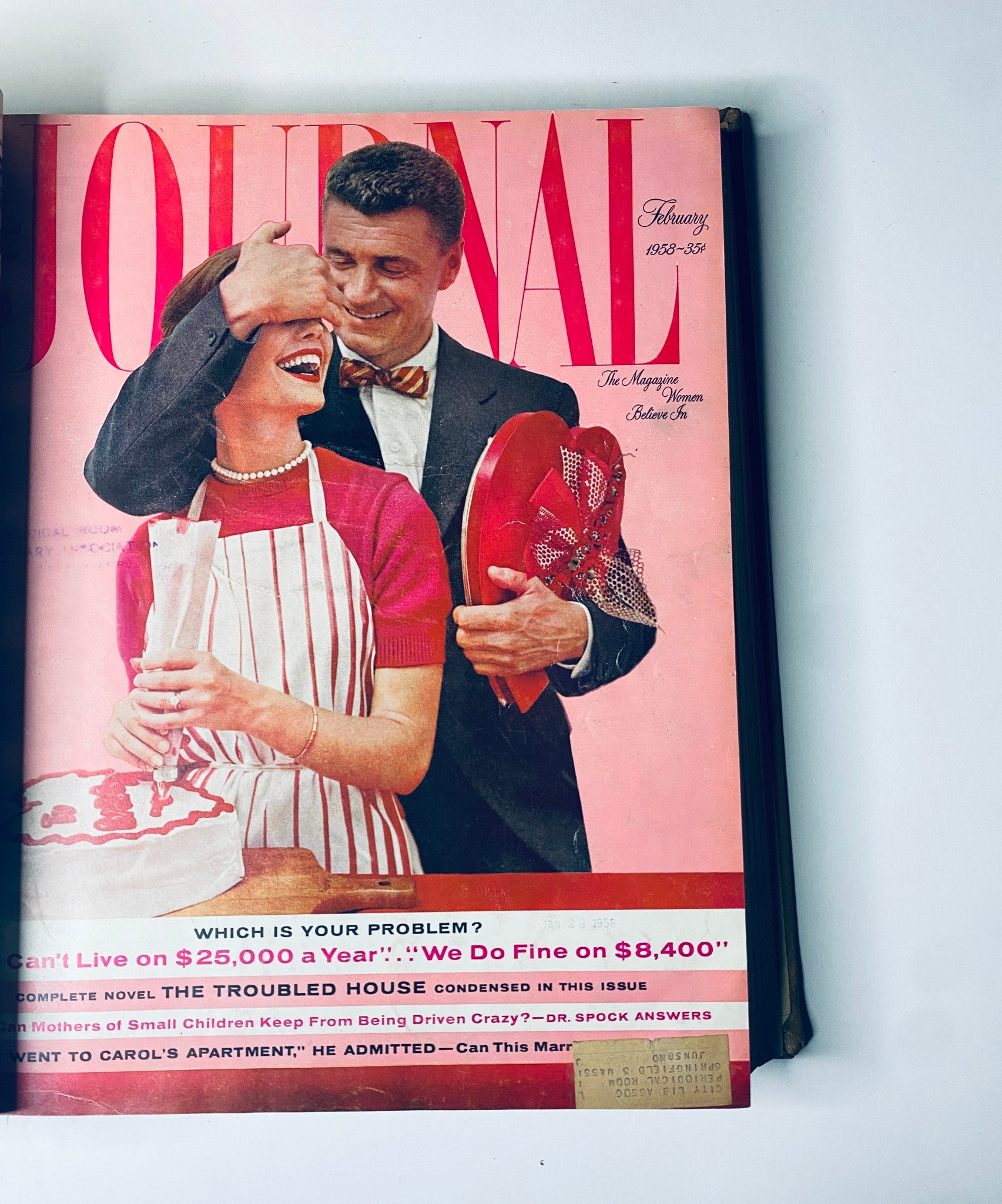 Cover of the Ladies' Home Journal magazine for February 1958, featuring a couple enjoying a playful moment with bright colors and bold typography. This edition explores themes of home life and personal finance.