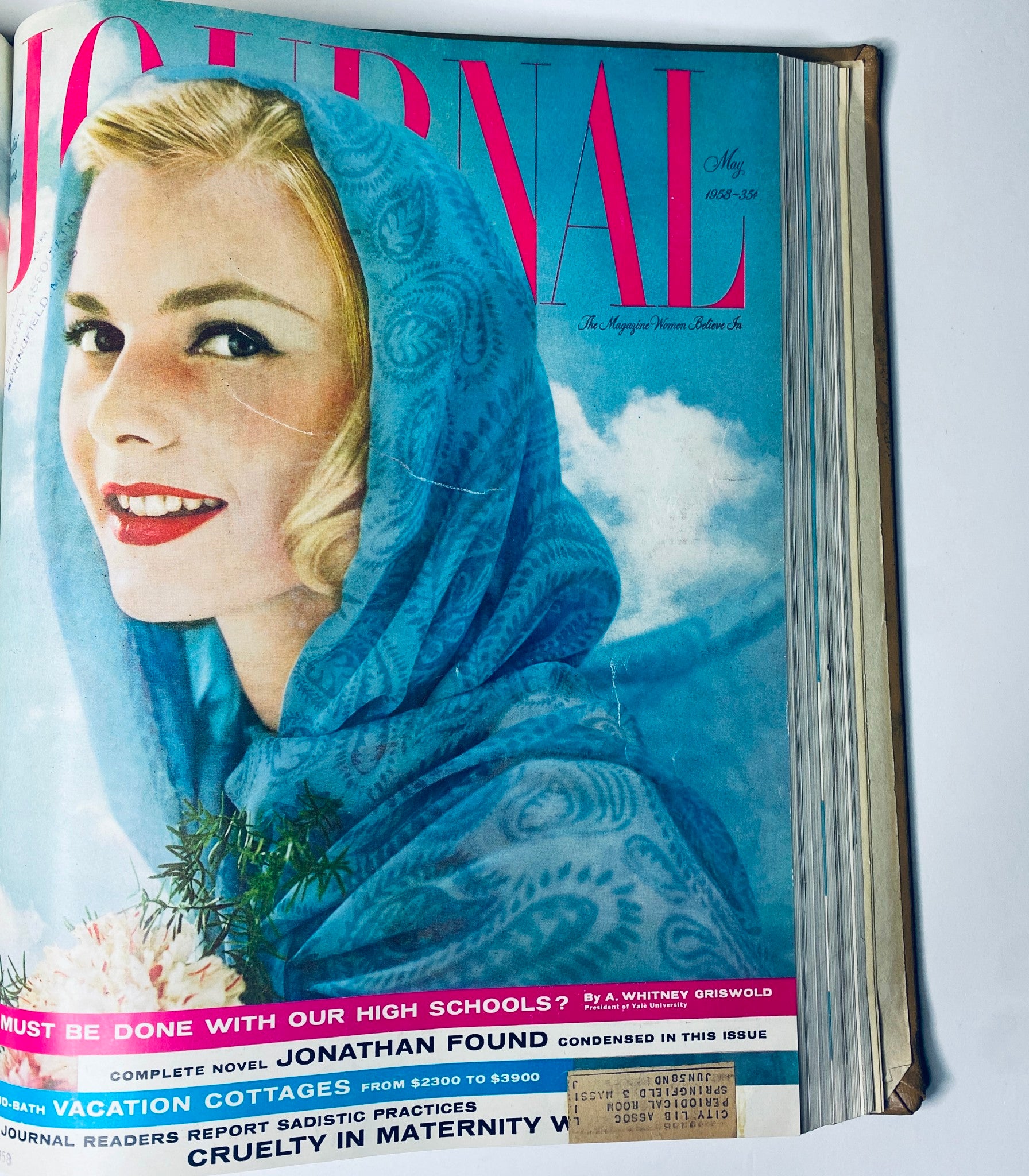 Cover of the Ladies' Home Journal magazine for May 1958, featuring a smiling woman in a blue shawl against a bright sky. The magazine emphasizes discussions on education and seasonal topics.