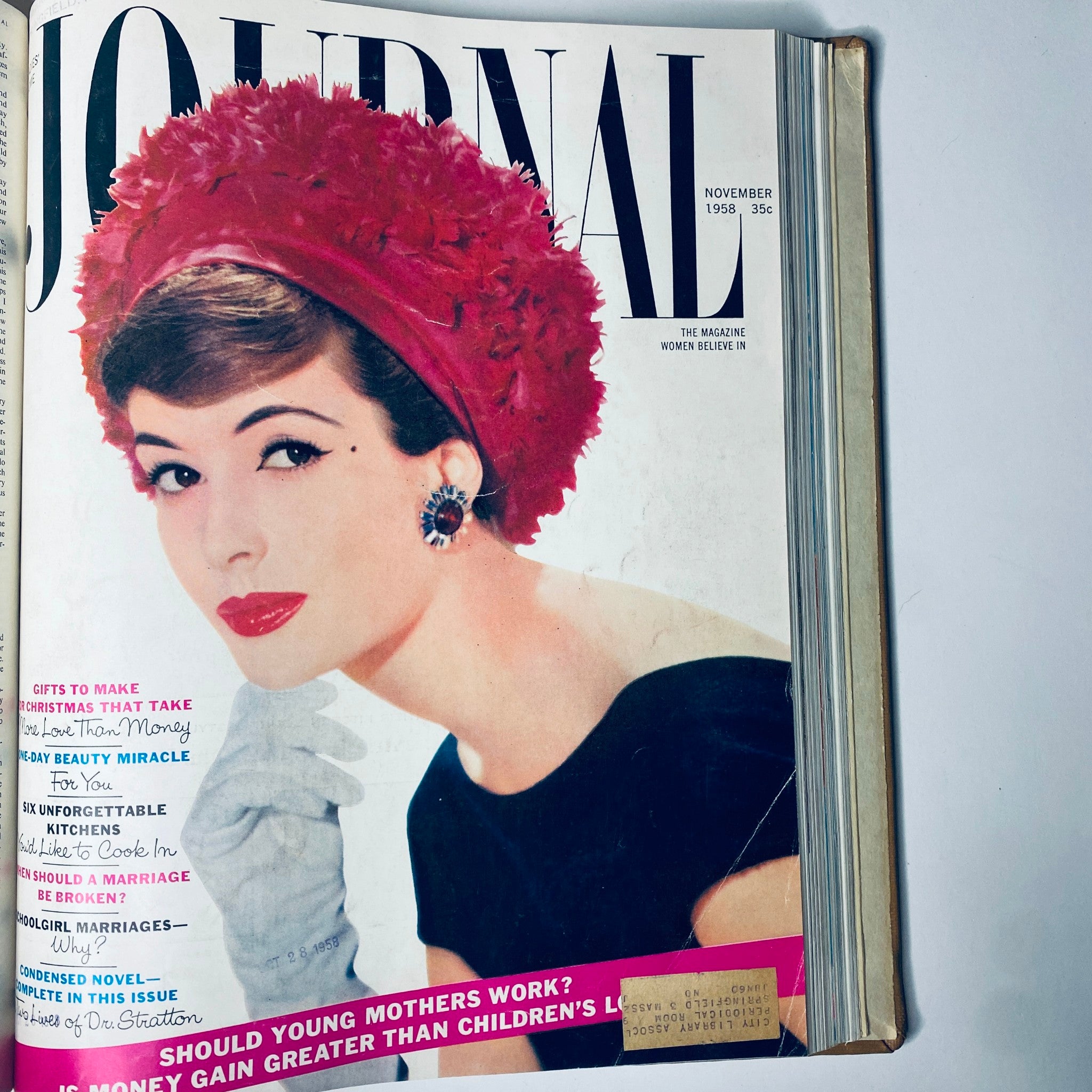 November 1958 cover of Ladies' Home Journal Bound Magazine featuring a portrait of an elegant woman in a red hat, showcasing fashion and holiday gift ideas.
