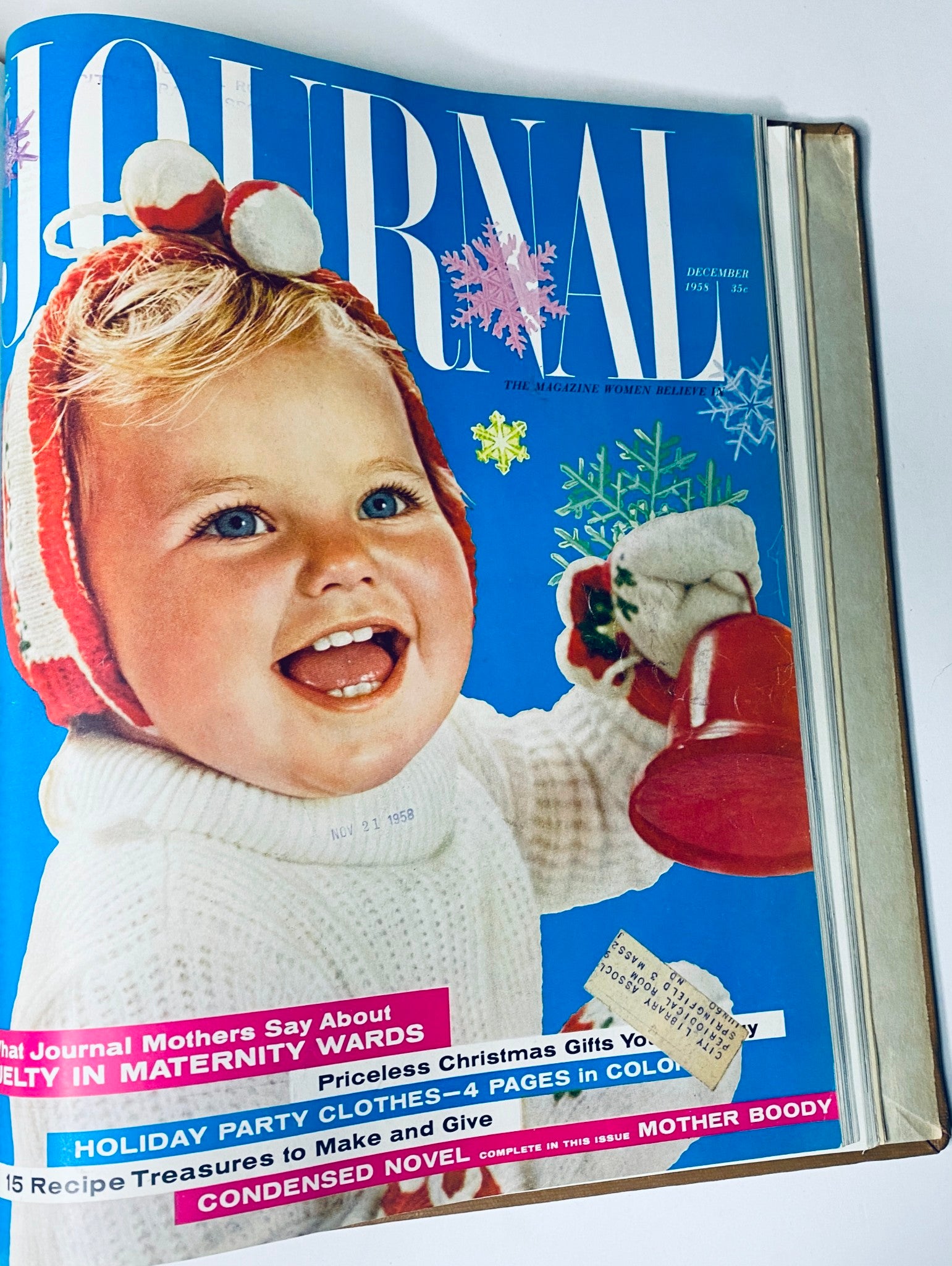 December 1958 cover of Ladies' Home Journal Bound Magazine featuring a cheerful child in winter attire, with festive holiday themes and gift suggestions.
