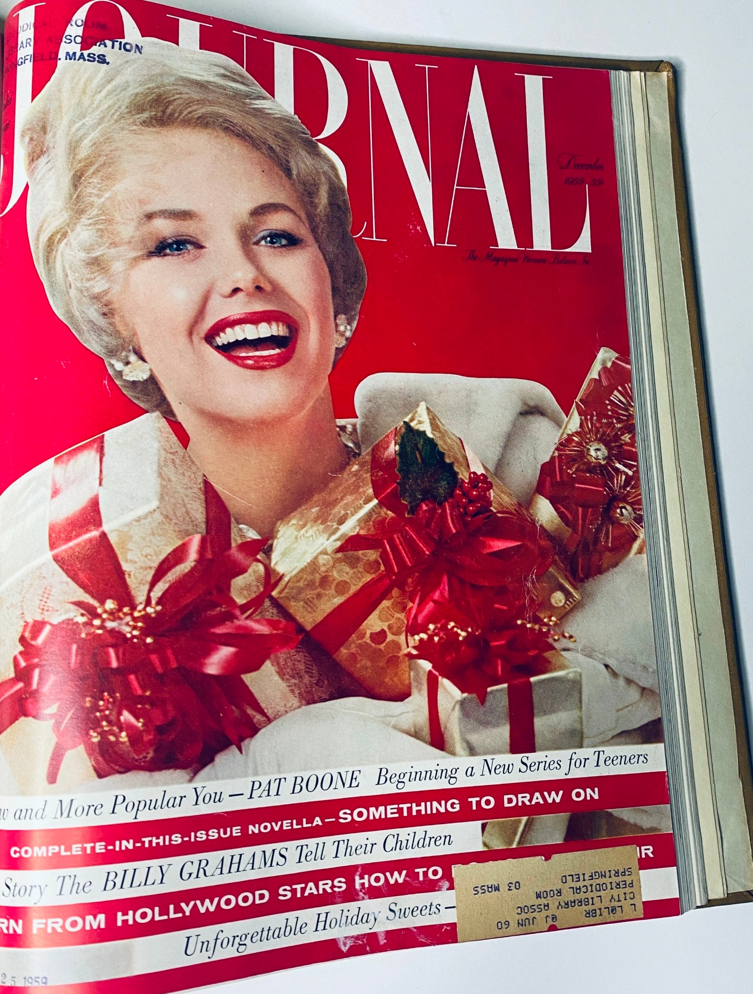 Ladies' Home Journal Bound Magazine December 1959 cover with a smiling woman holding holiday gifts, illustrating festive 1950s themes.