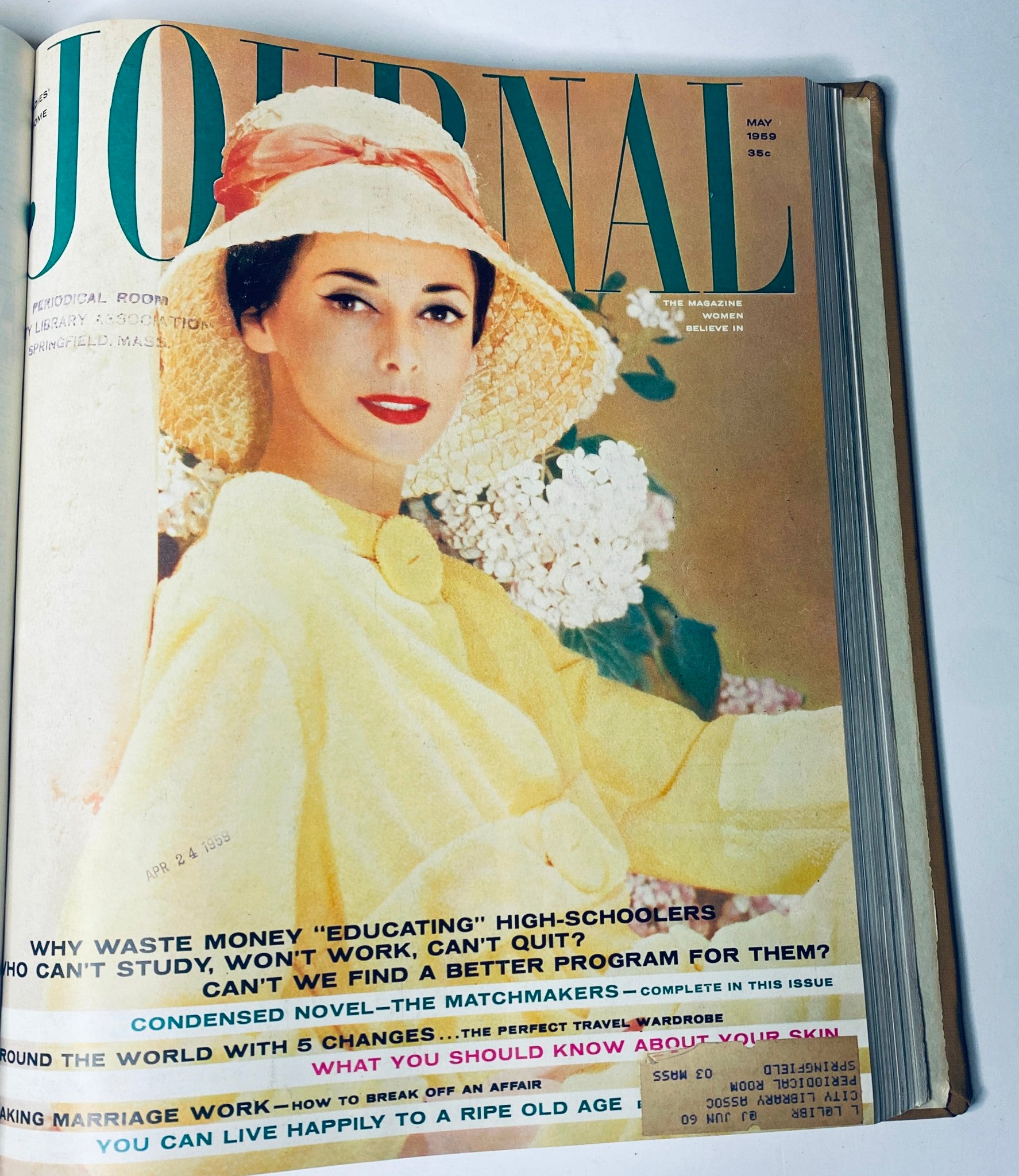 Cover of Ladies' Home Journal, May 1959 issue, depicting a woman in a sun hat with flowers, highlighting mid-century style and topics on education and marriage.