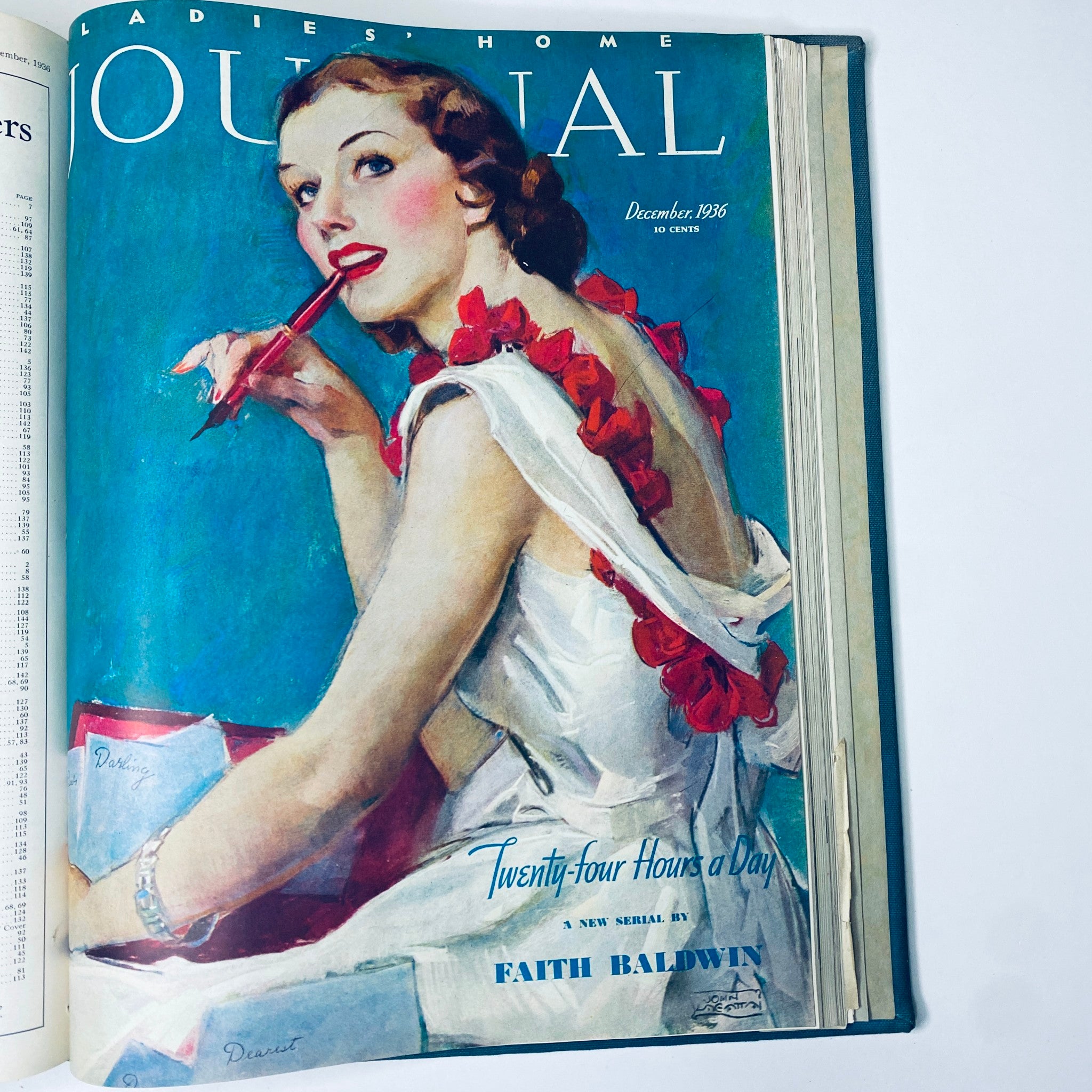 Cover page of the Ladies' Home Journal Bound Magazine 1936 showcasing a woman with a red flowered accessory, writing with a pen, featuring the title 'Ladies' Home Journal December 1936' and article 'Twenty-four Hours a Day' by Faith Baldwin.
