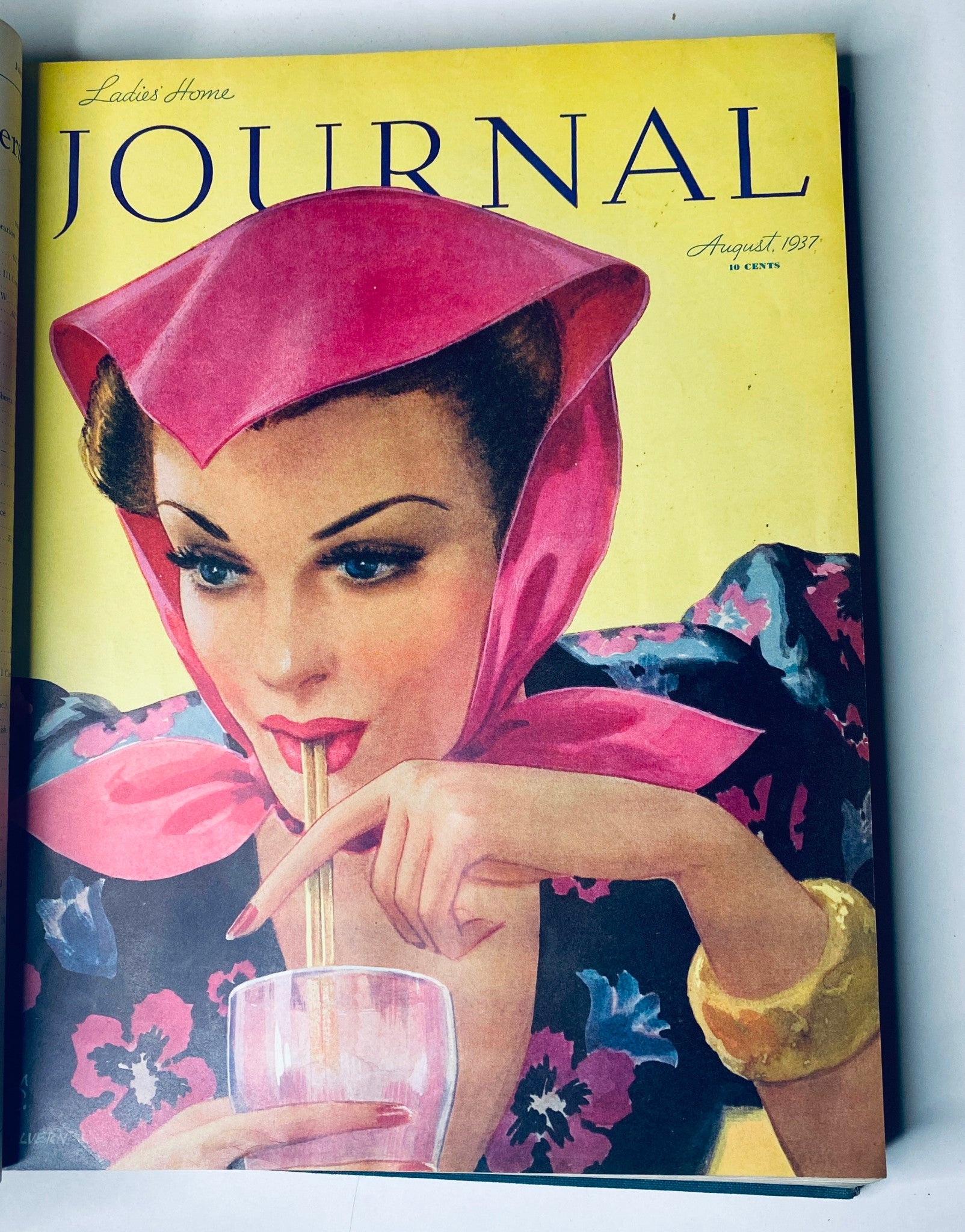 Cover of Ladies' Home Journal for August 1937 depicting a glamorous woman with red lips and a pink headscarf, enjoying a colorful drink, highlighting 1930s fashion.