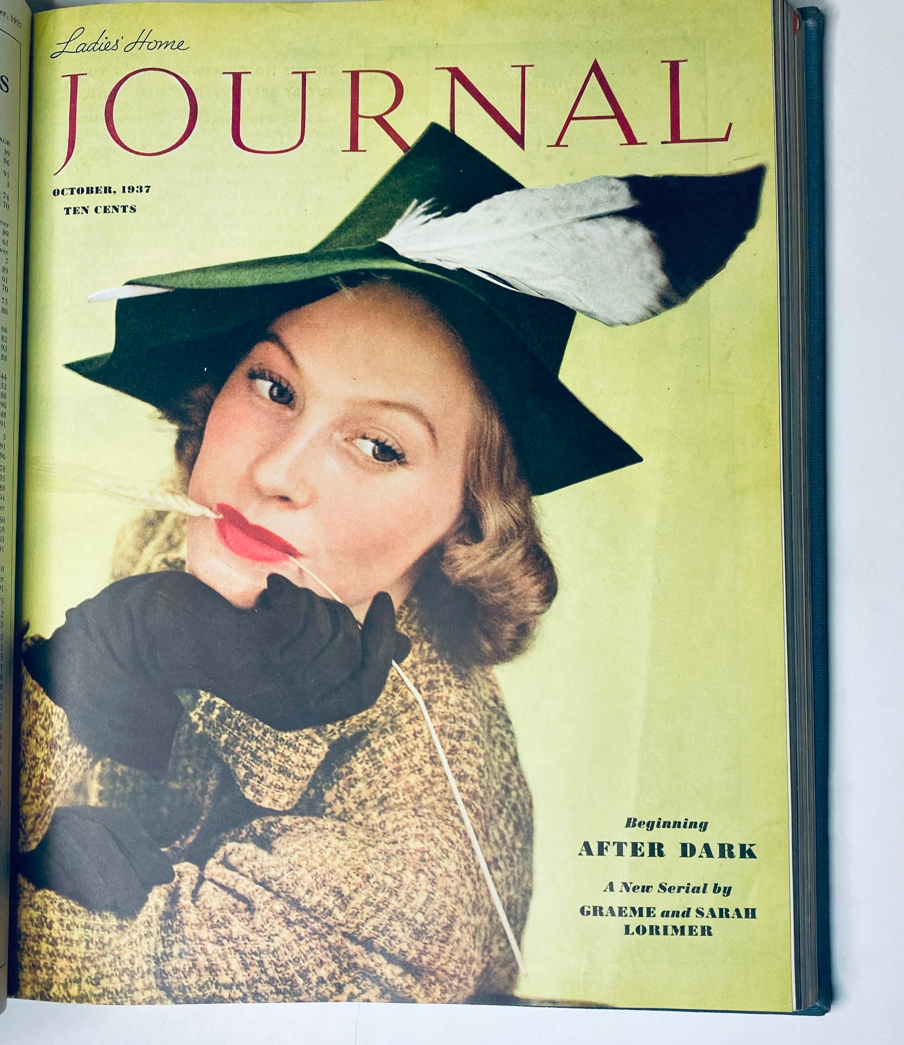 Cover of Ladies' Home Journal for October 1937 showcasing a fashionable woman wearing a green hat with a feather, illustrating style and elegance of the late 1930s.