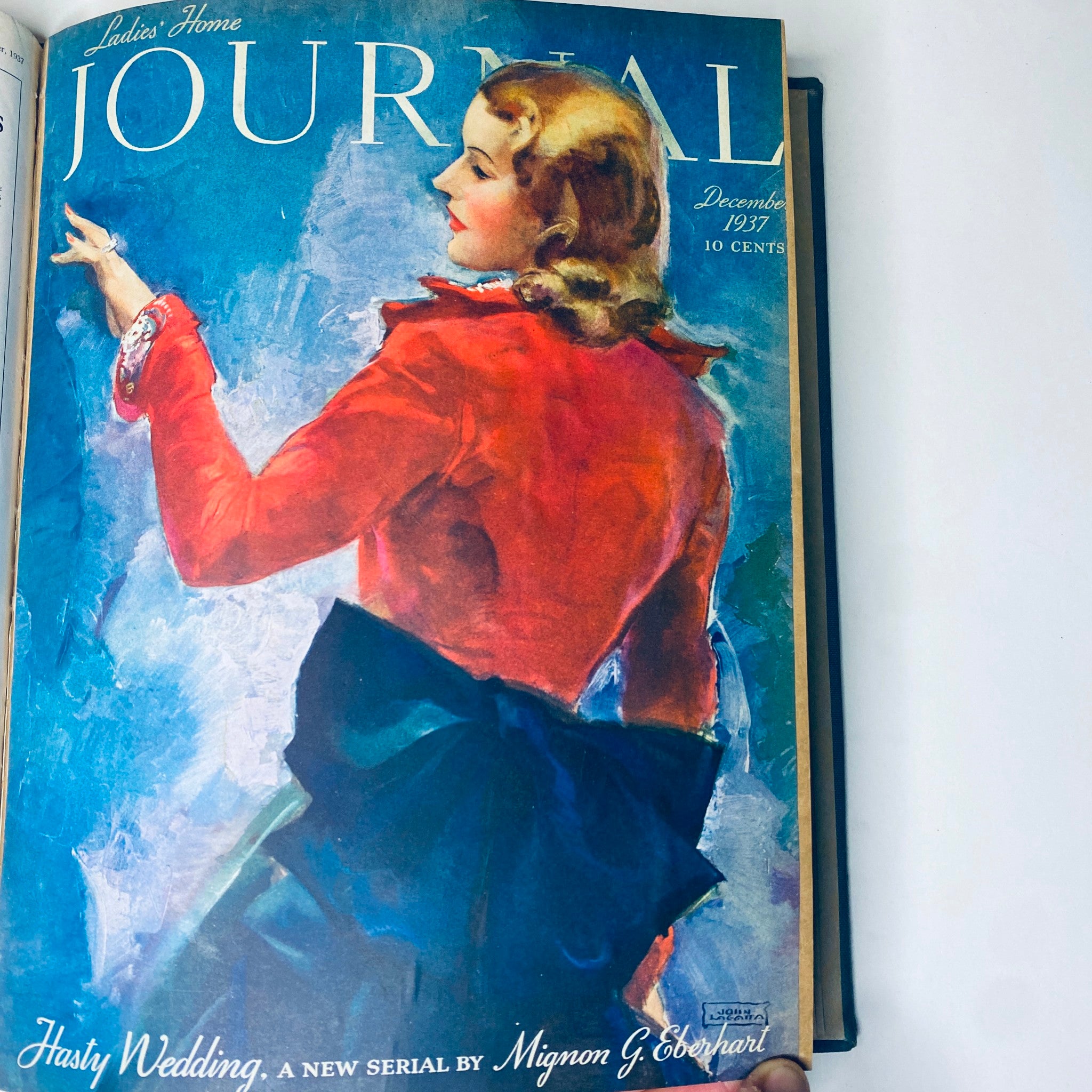 Cover of Ladies' Home Journal December 1937 featuring a woman in a red outfit looking back, part of the library bound magazine collection for the full year 1937.