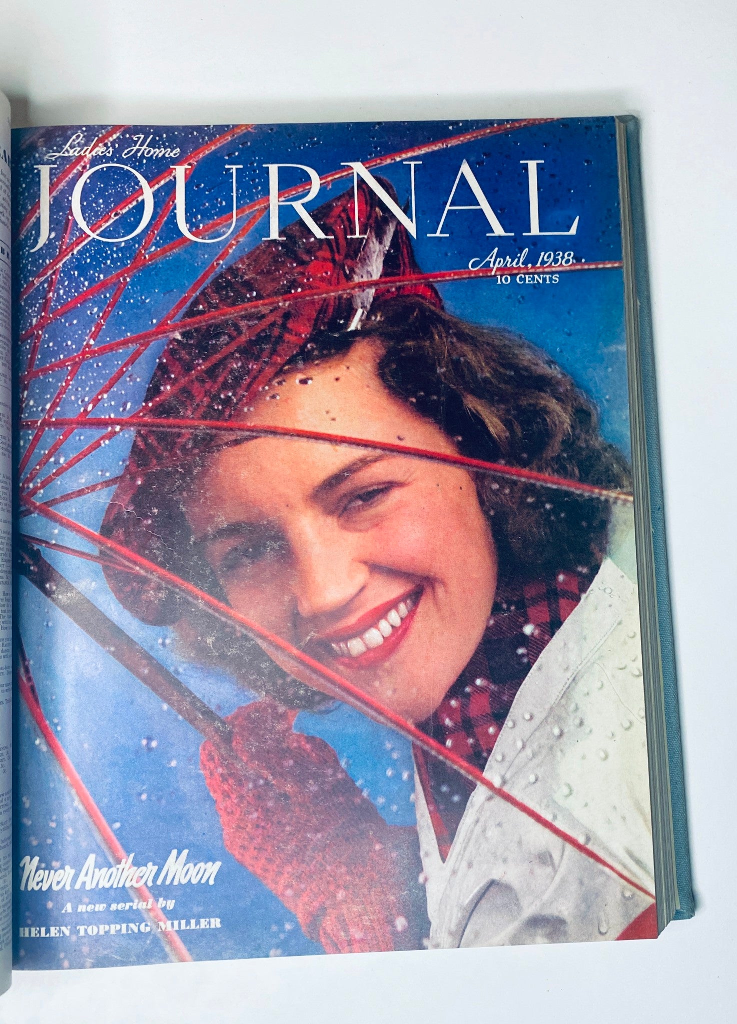 Ladies' Home Journal Library Bound Magazine 1938 - April cover depicting a smiling woman with an umbrella, themed around springtime in 1938.