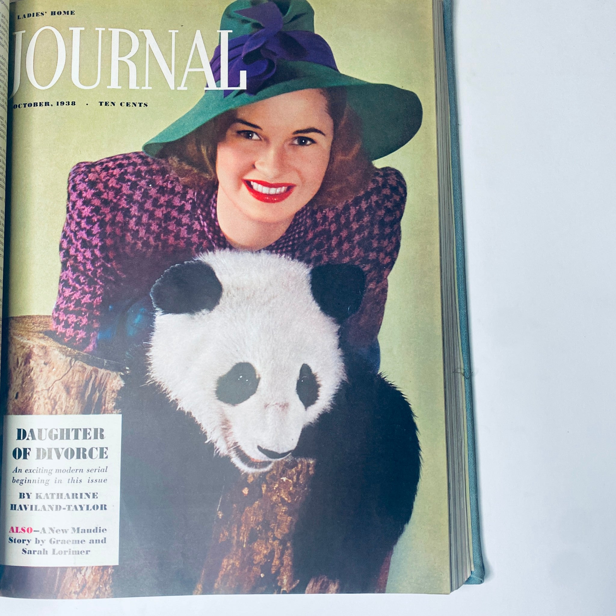 Cover of the Ladies' Home Journal October 1938 issue, featuring a woman in a stylish hat with a panda, representing the playful spirit of vintage fashion.