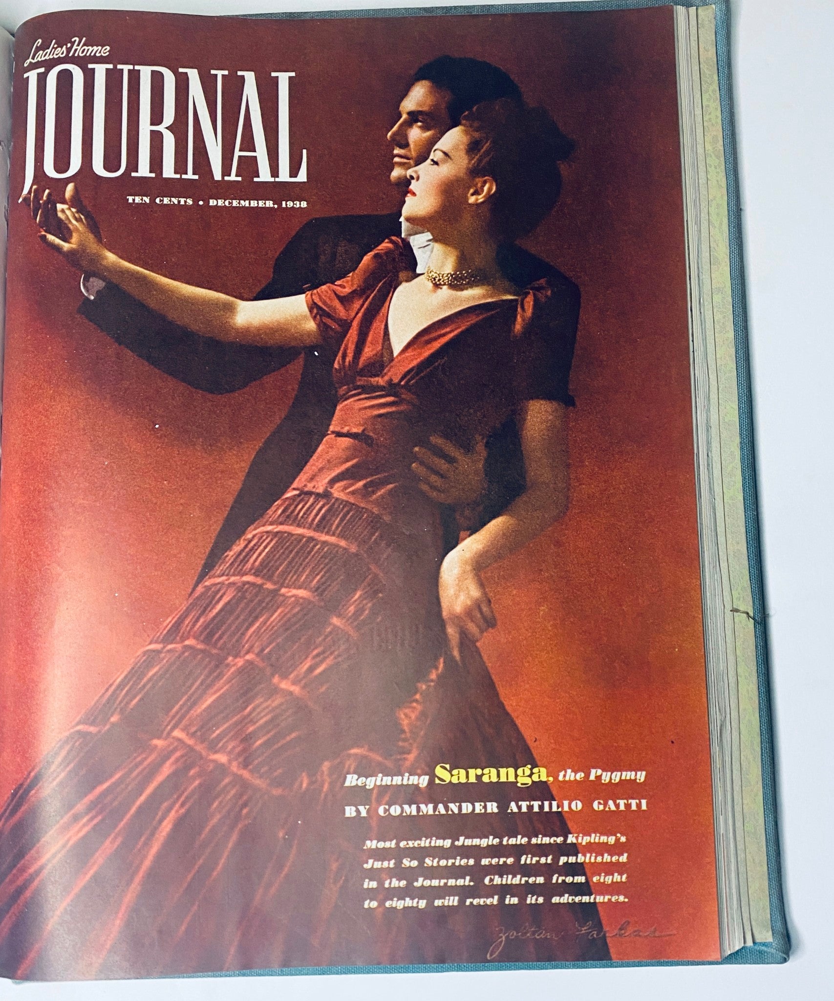 Cover of the Ladies' Home Journal, December 1938 edition. Features a dramatic illustration of a couple dressed elegantly, introducing the story 'Saranga, the Pygmy' by Commander Attilio Gatti.