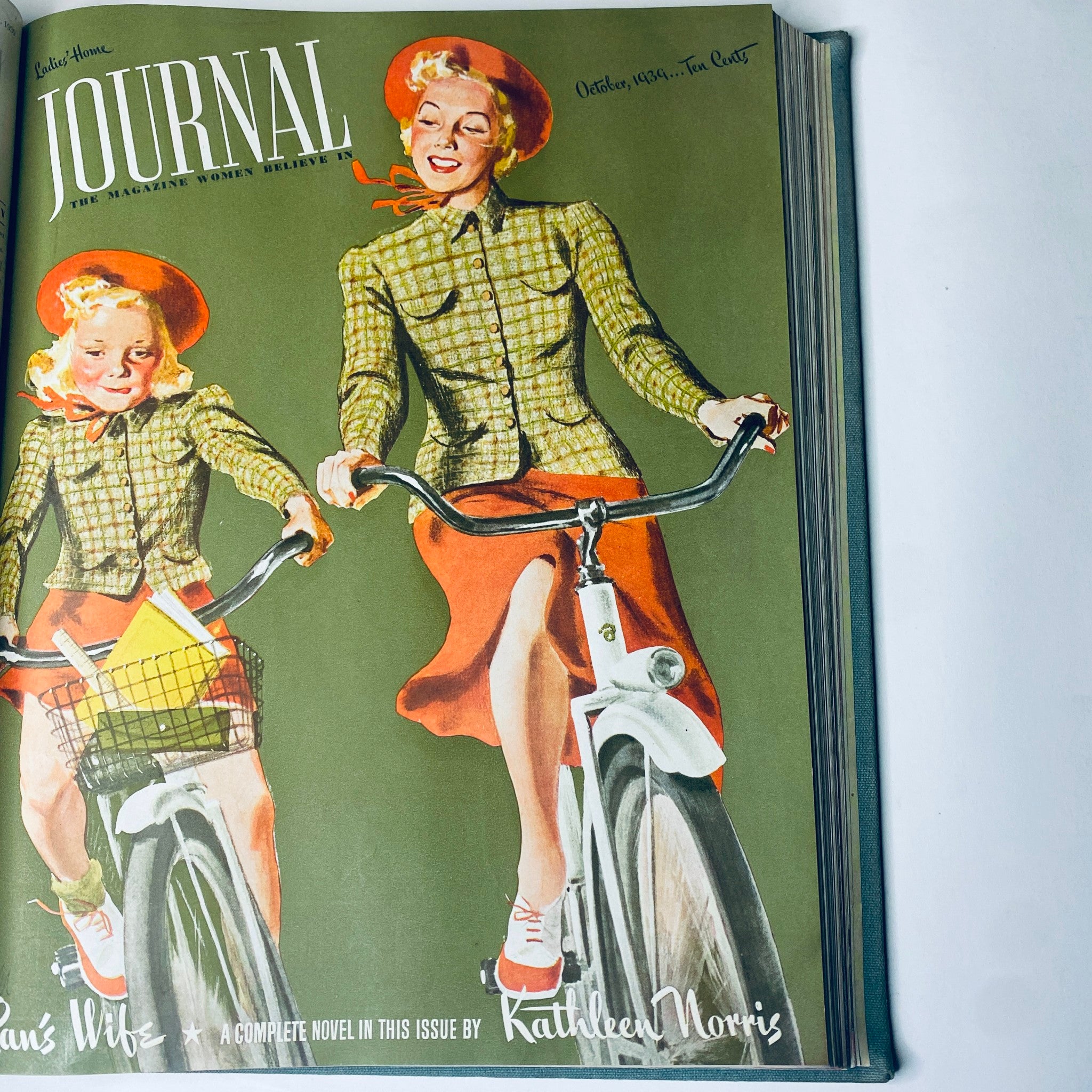 Cover of Ladies' Home Journal October 1939 depicting a mother and daughter riding bicycles. The magazine is part of the 1939 bound collection from January to December.